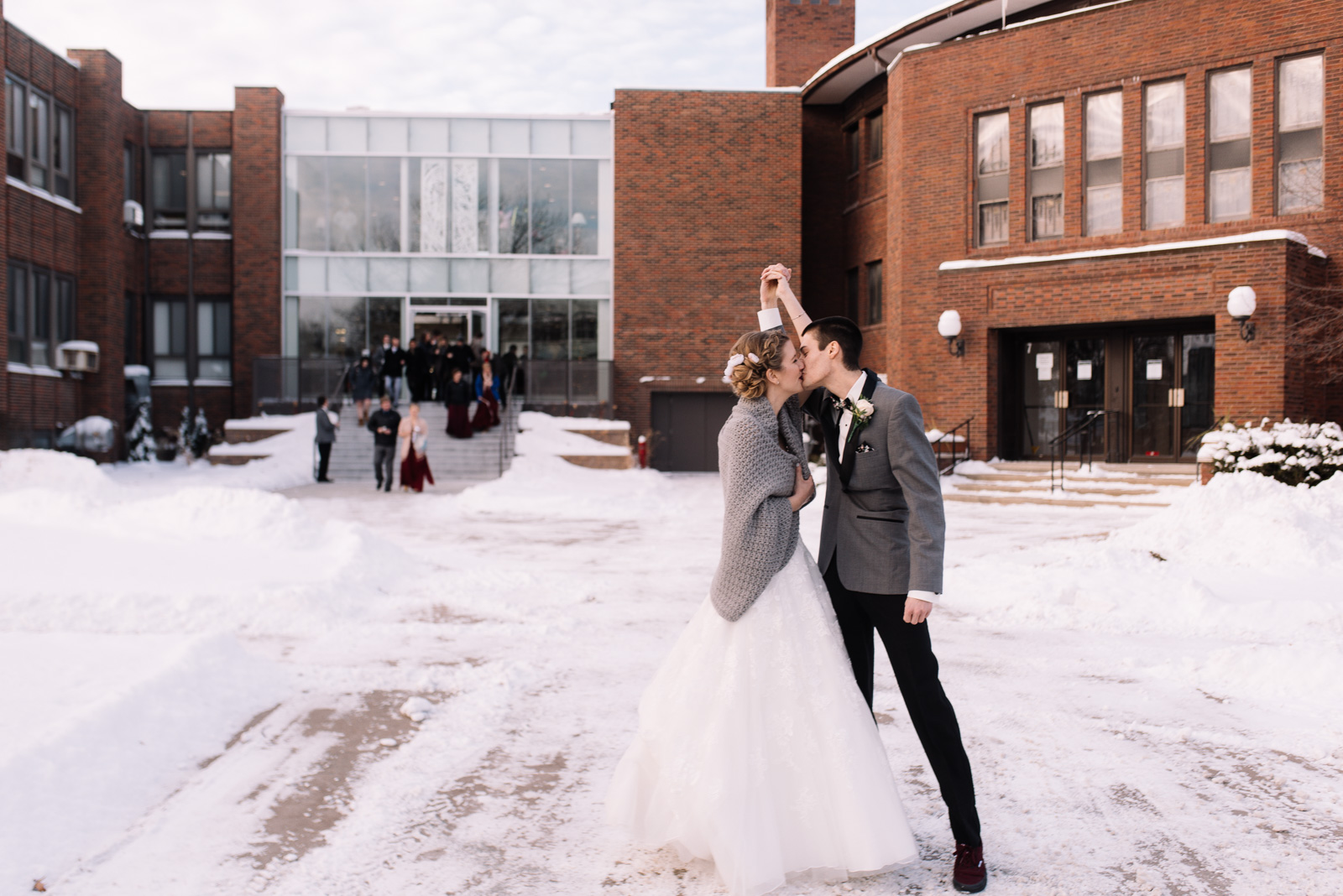 Bride and groom kissing outside St. Paul's United Methodist Church Winter Wedding