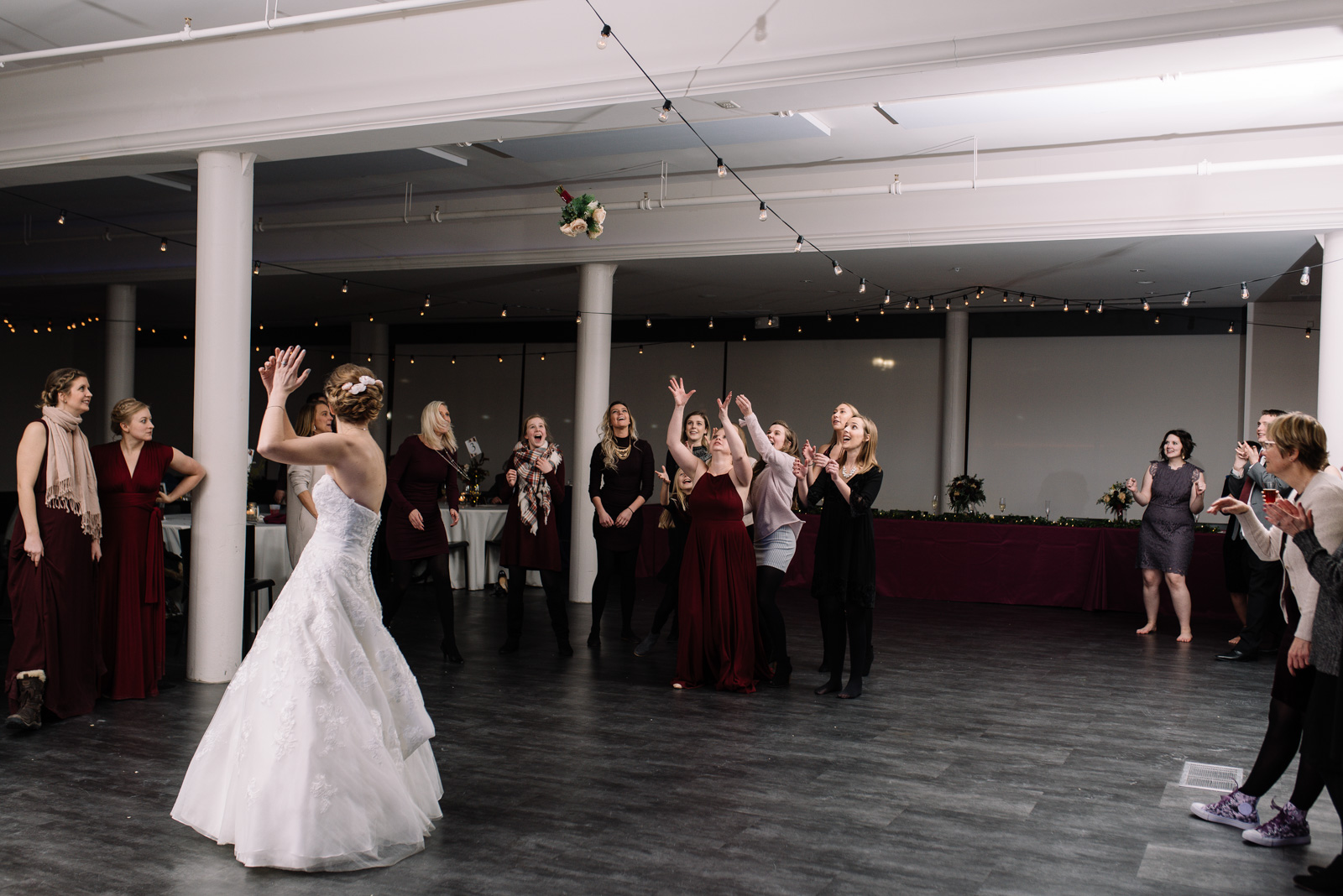 bouquet toss string lights eastbank wedding venue