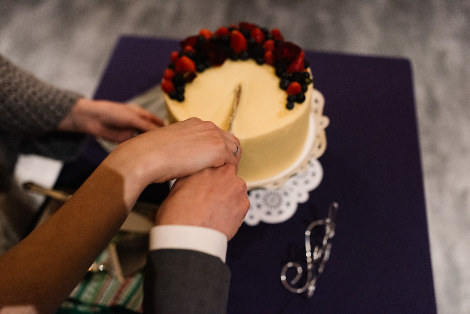 bride and groom cutting wedding cake