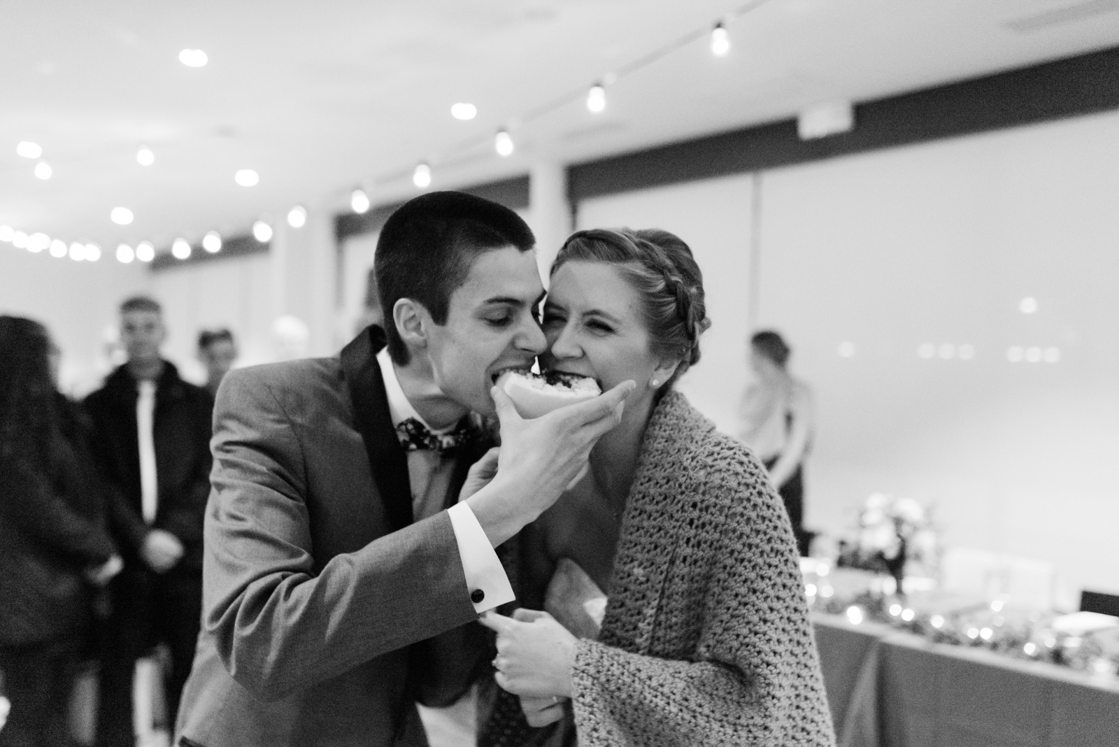 bride and groom eating cake eastbank wedding venue