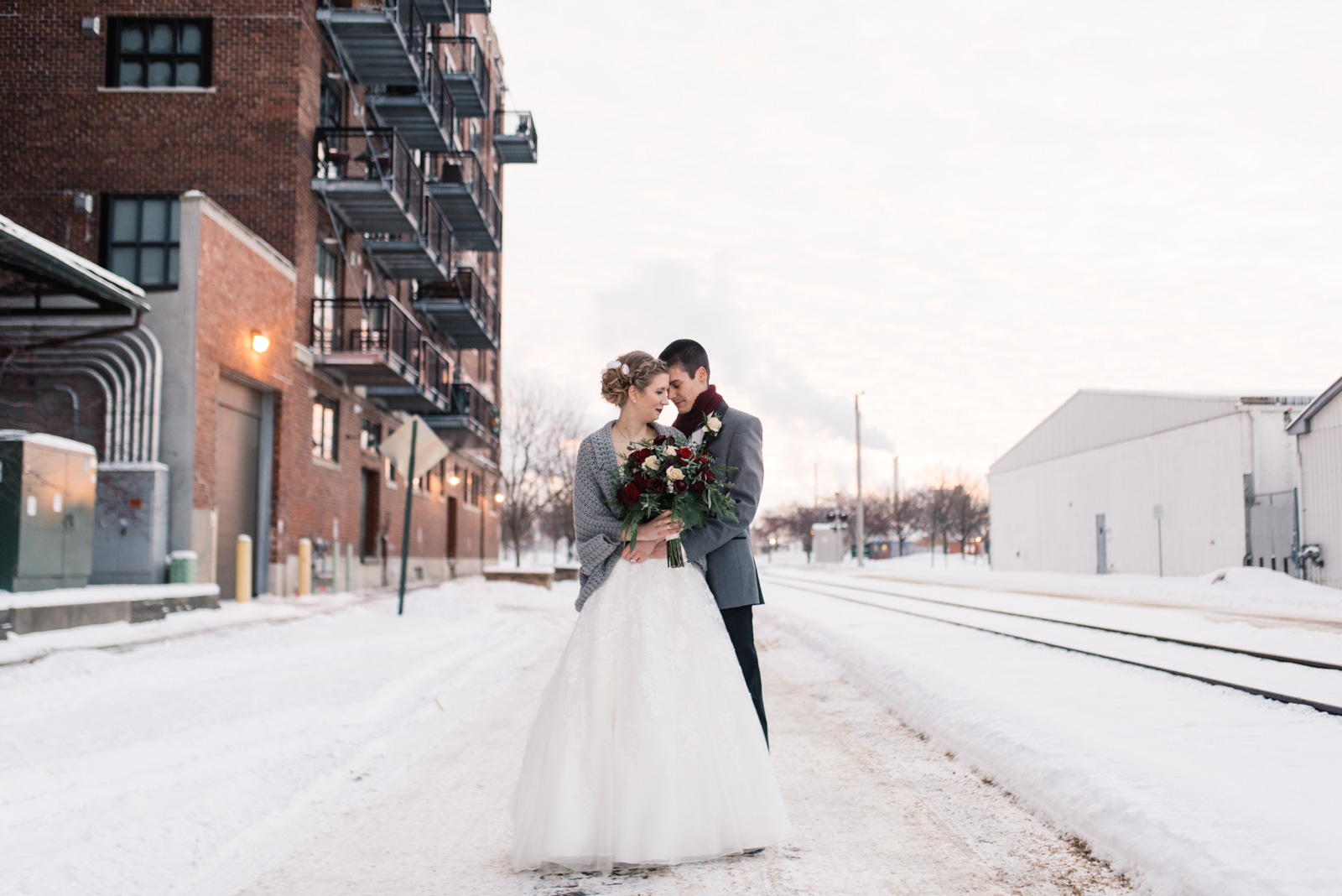 bride and groom standing in snow cedar rapids winter wedding