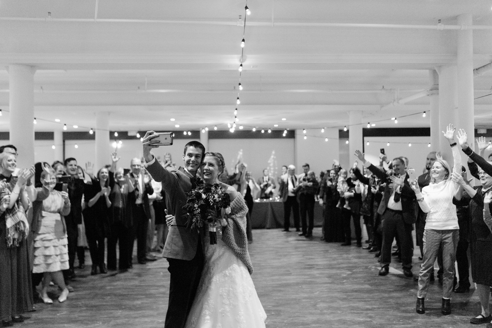 bride and groom taking selfie with wedding guests Cedar Rapids wedding venue