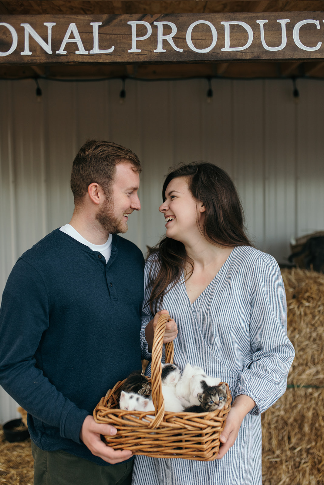 engaged couple with basket of cats