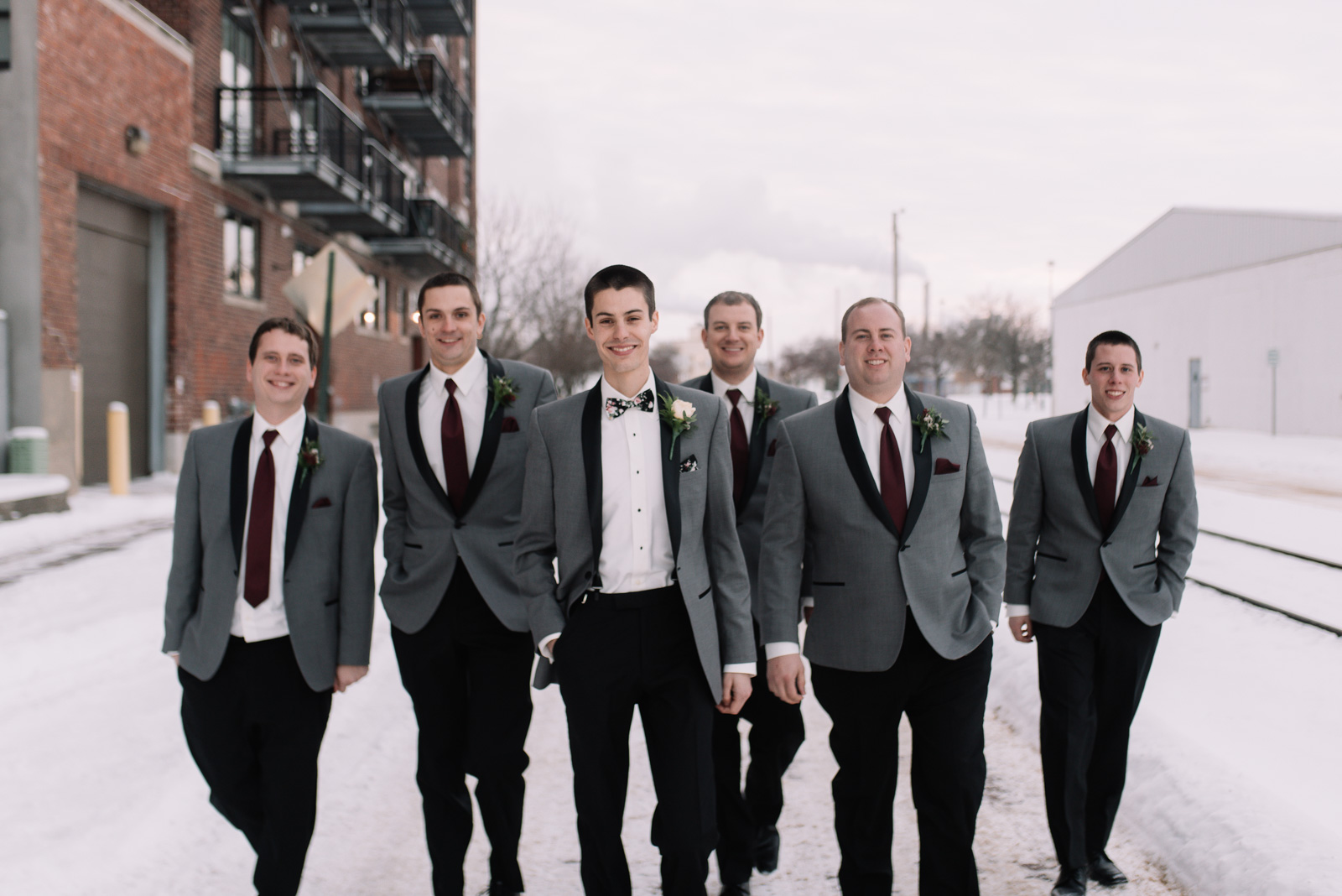 groom and groomsmen walking cedar rapids winter wedding