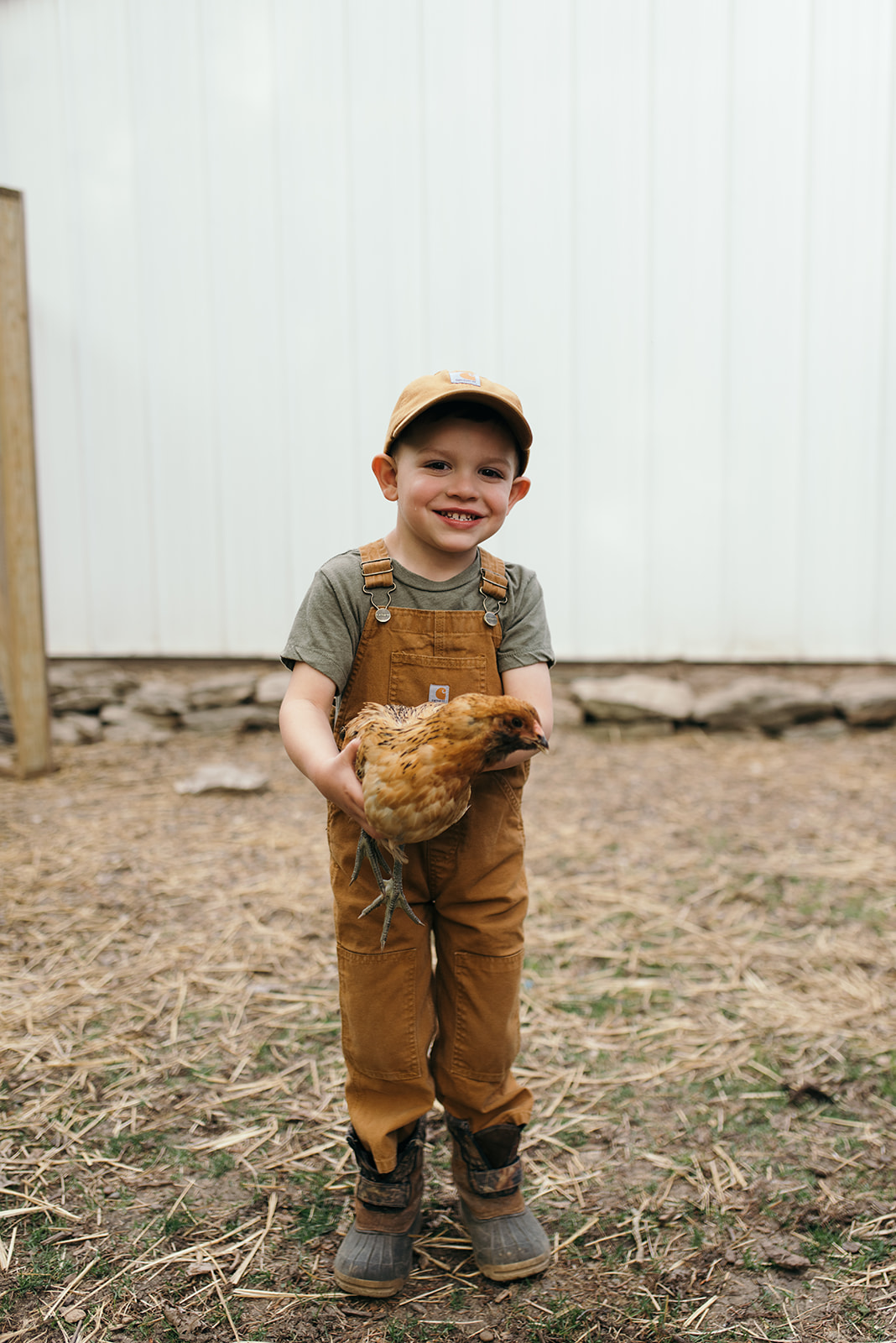 tad-holding-chicken-on-farm