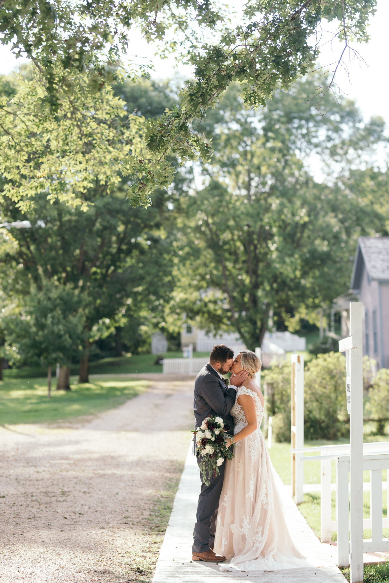 bride and groom kissing September wedding Ushers Ferry Historic Village wedding venue