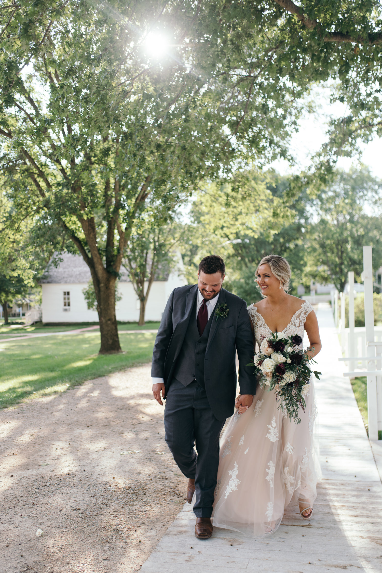 bride and groom walking Ushers Ferry Historic Village wedding venue sunset