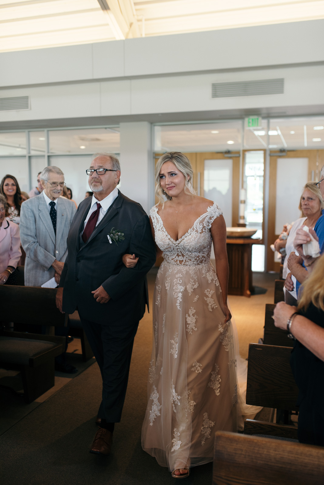 bride walking down aisle St. John XXIII Parish wedding ceremony