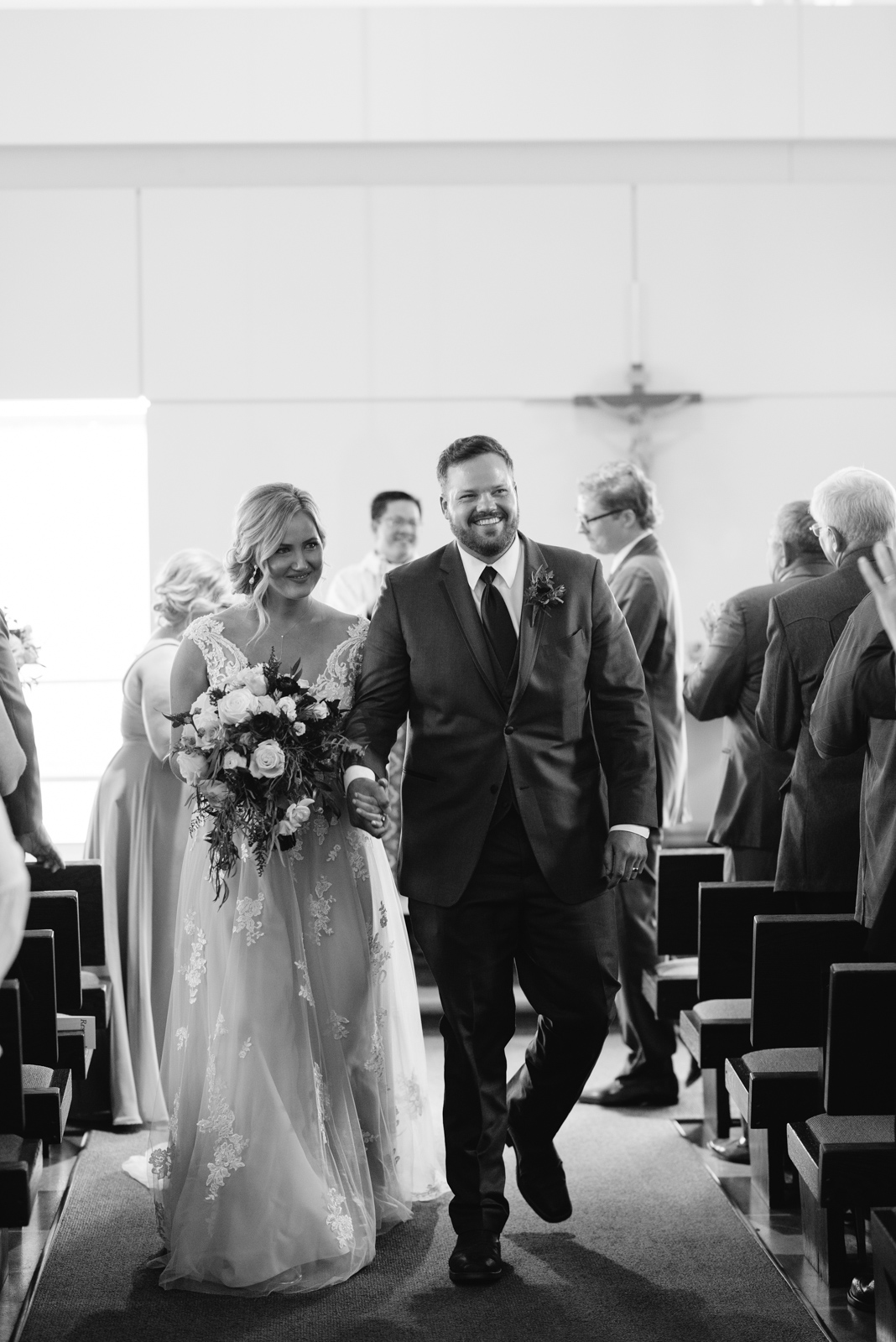 bride and groom walking down aisle St. John XXIII Parish wedding ceremony