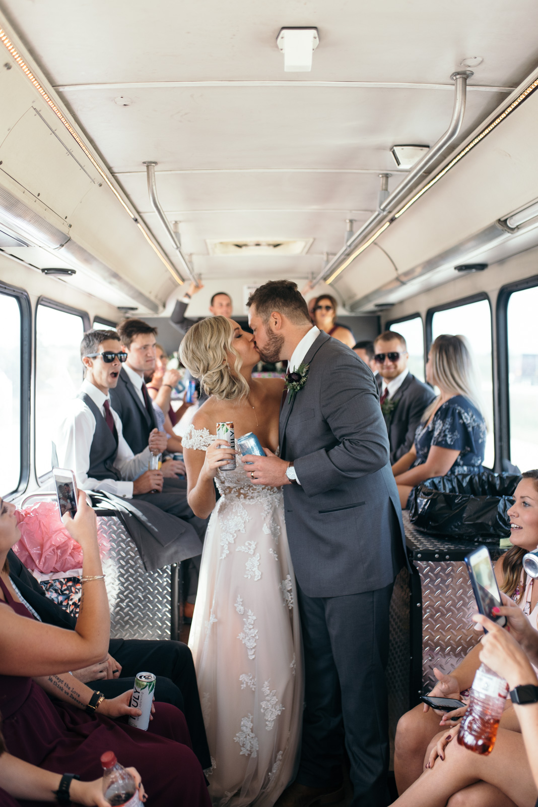 bride and groom kissing on cedar rapids wedding party bus