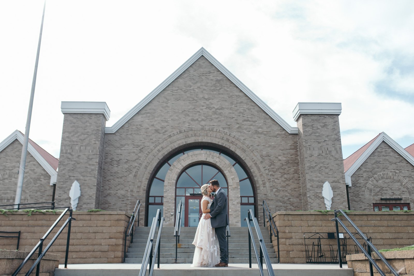 bride and groom kissing outside National Czech & Slovak Museum & Library wedding