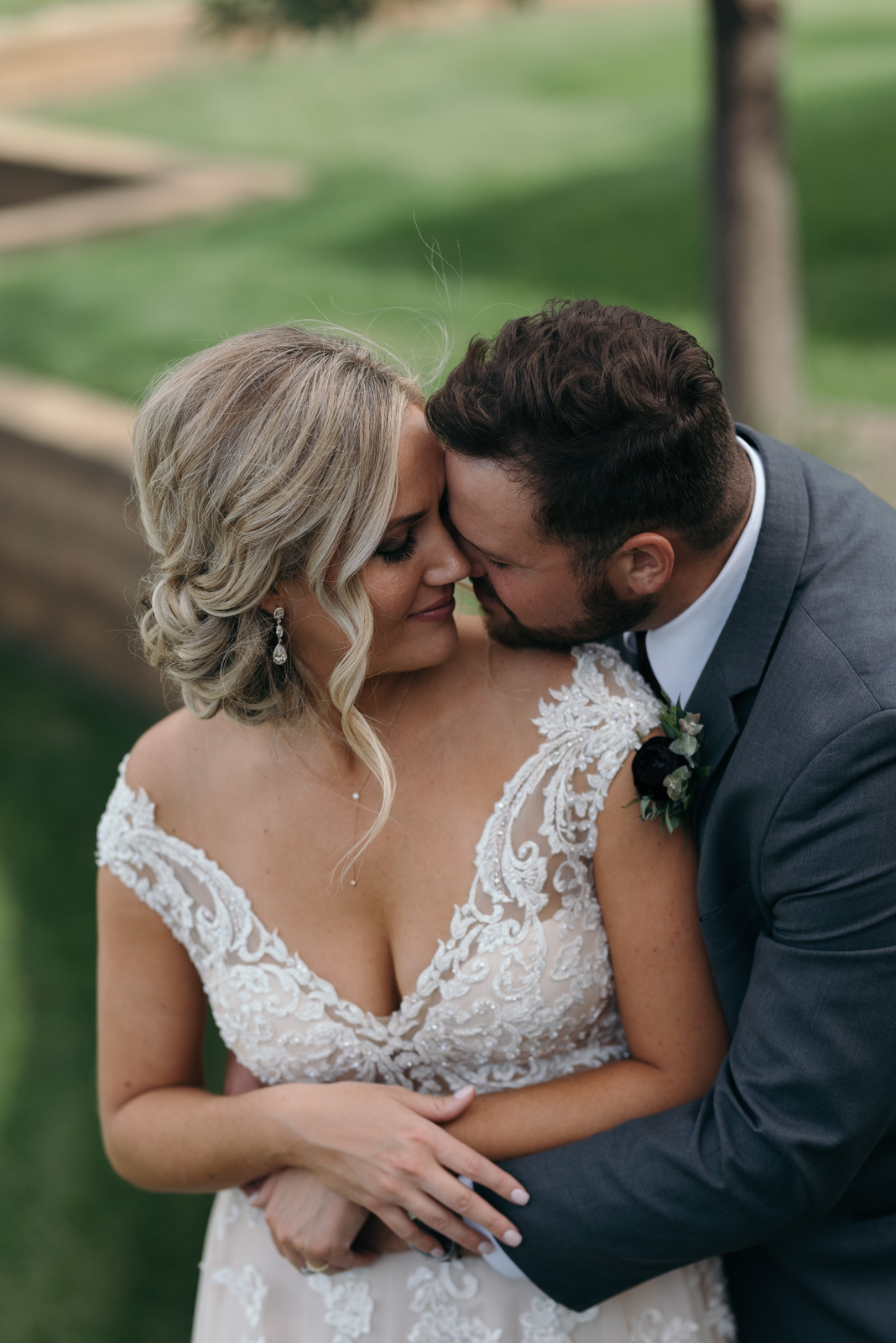 bride and groom cuddling outside czech village wedding