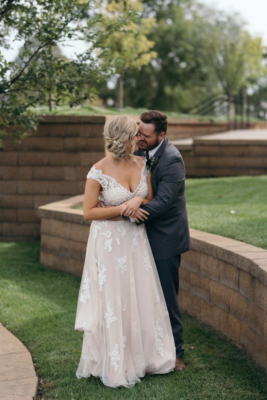 bride and groom cuddling outside cedar rapids wedding