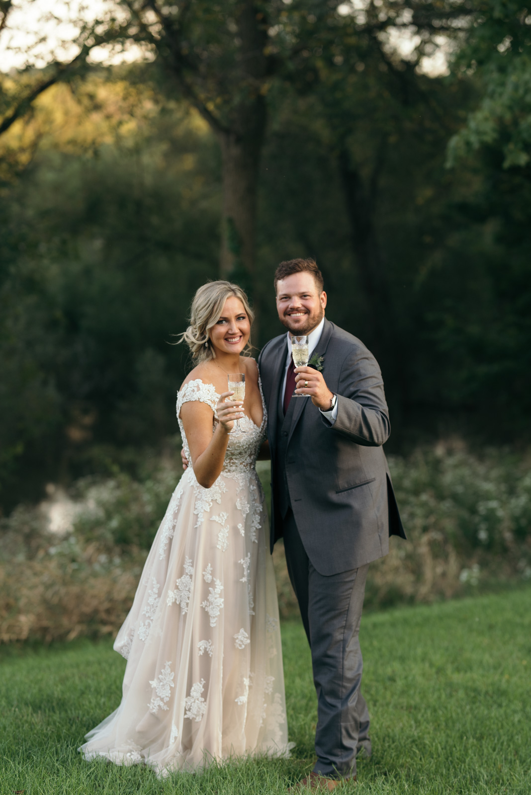 bride and groom holding champagne Ushers Ferry Historic Village wedding venue 