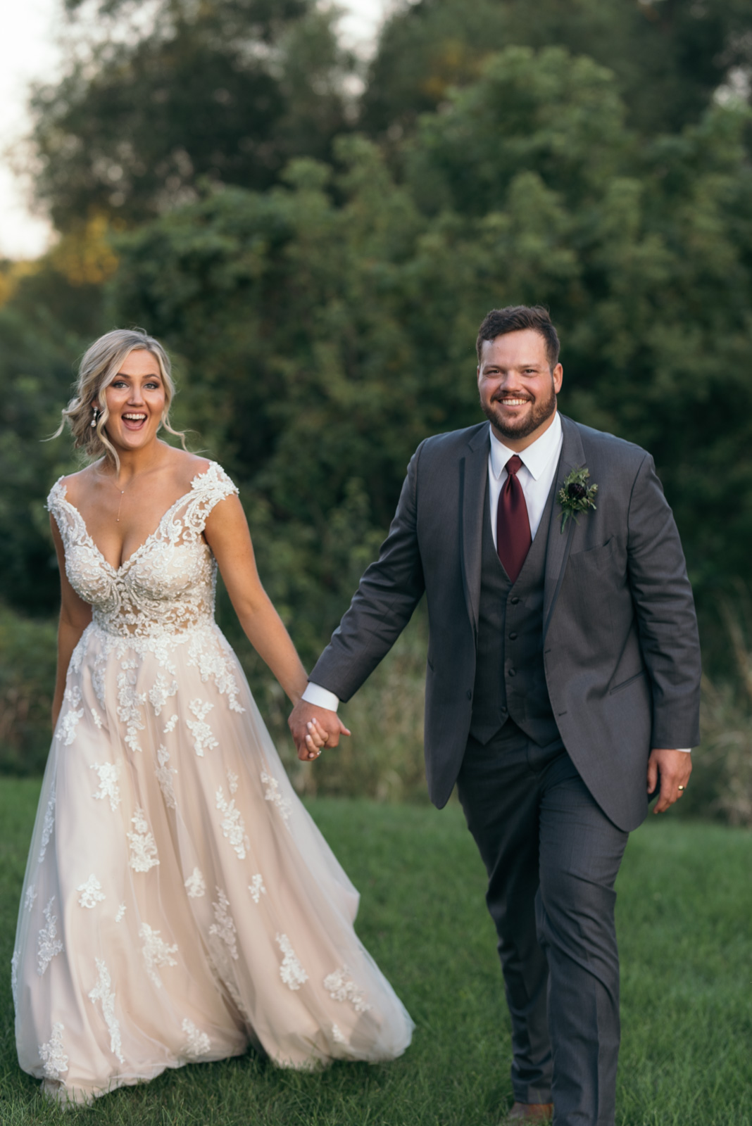 bride and groom holding hands cedar rapids wedding