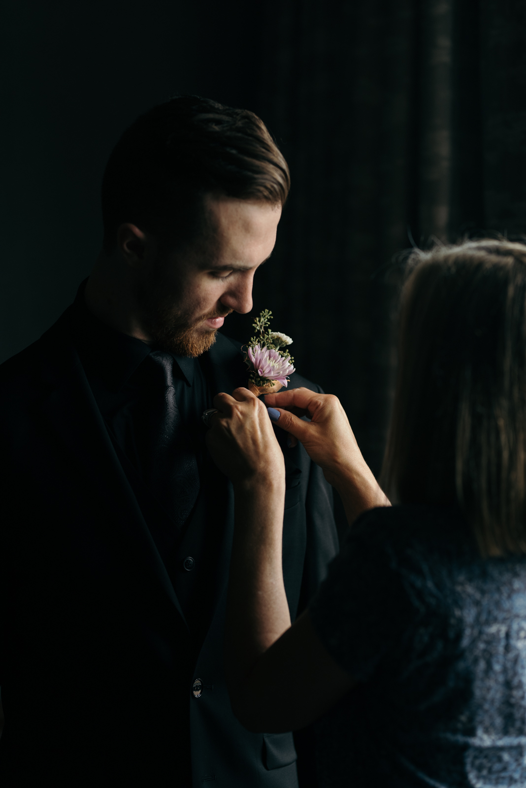 groom getting boutonniere Coralville Marriott Hotel Wedding