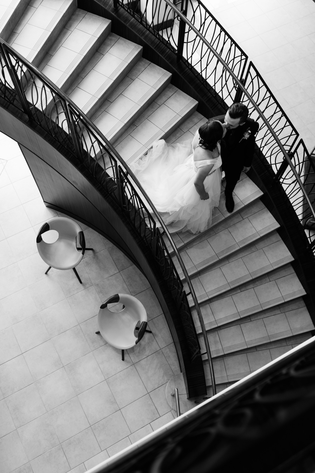 bride and groom on staircase at Coralville Marriott Hotel Wedding