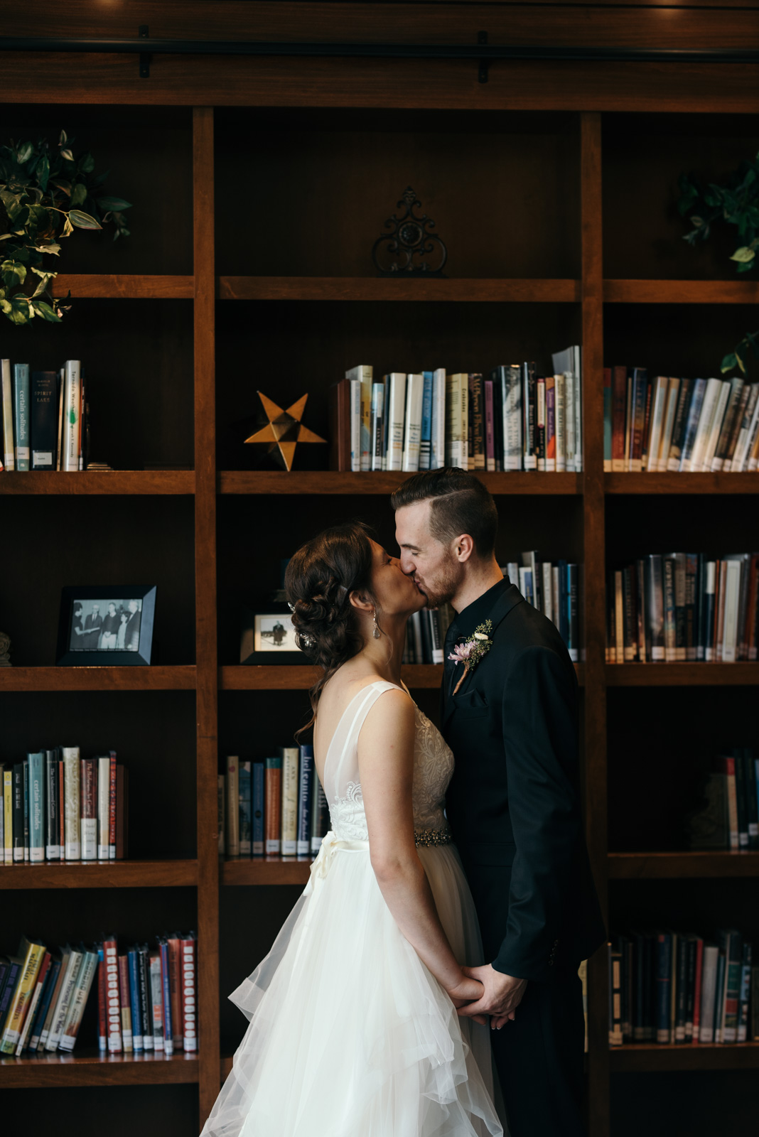 bride and groom kissing in the library Coralville Marriott Hotel Wedding