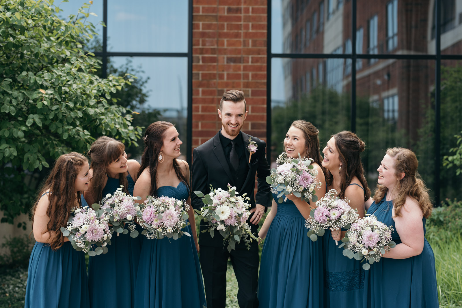 groom with bridesmaids Coralville Iowa august wedding