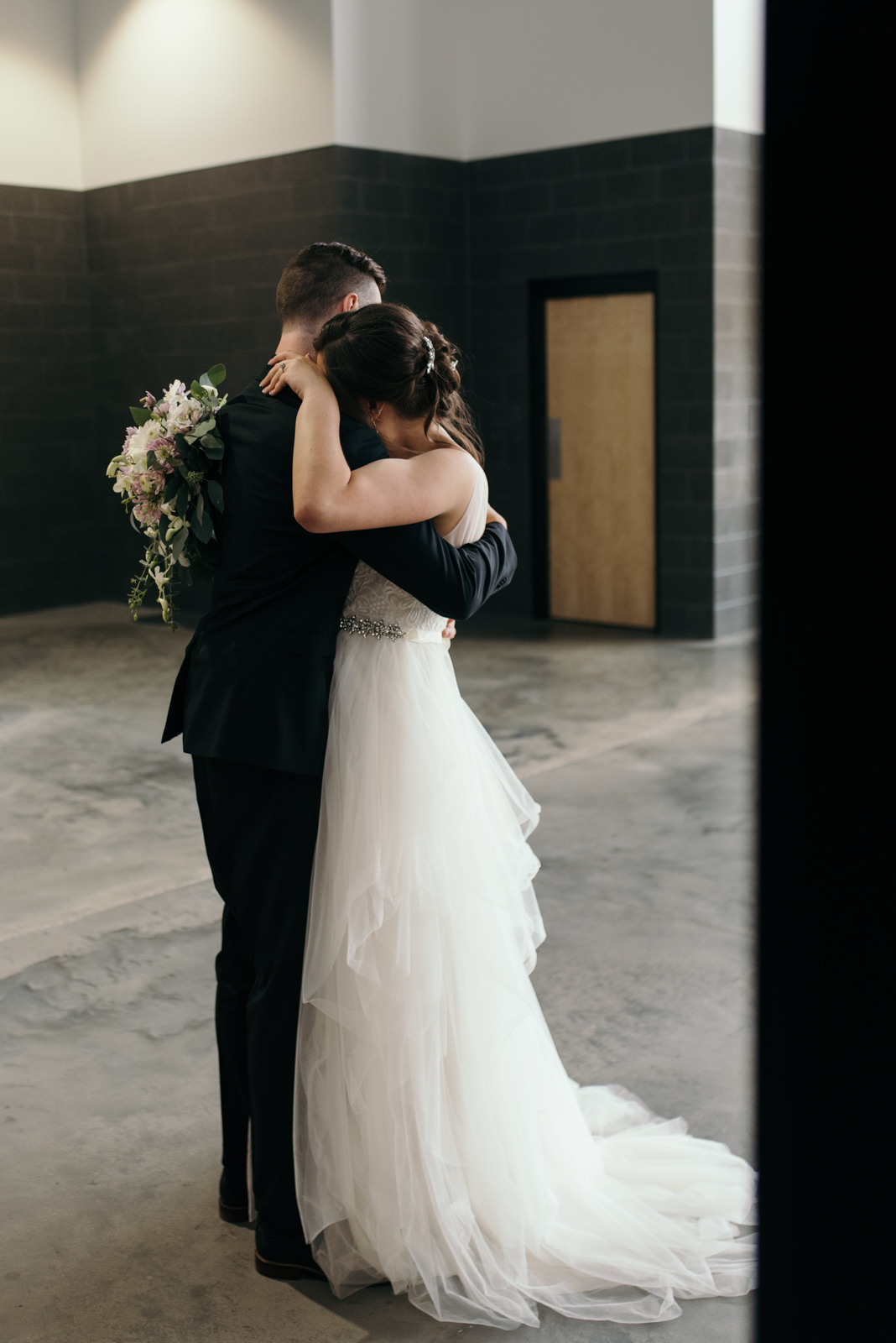 bride and groom hugging veritas church Iowa City wedding