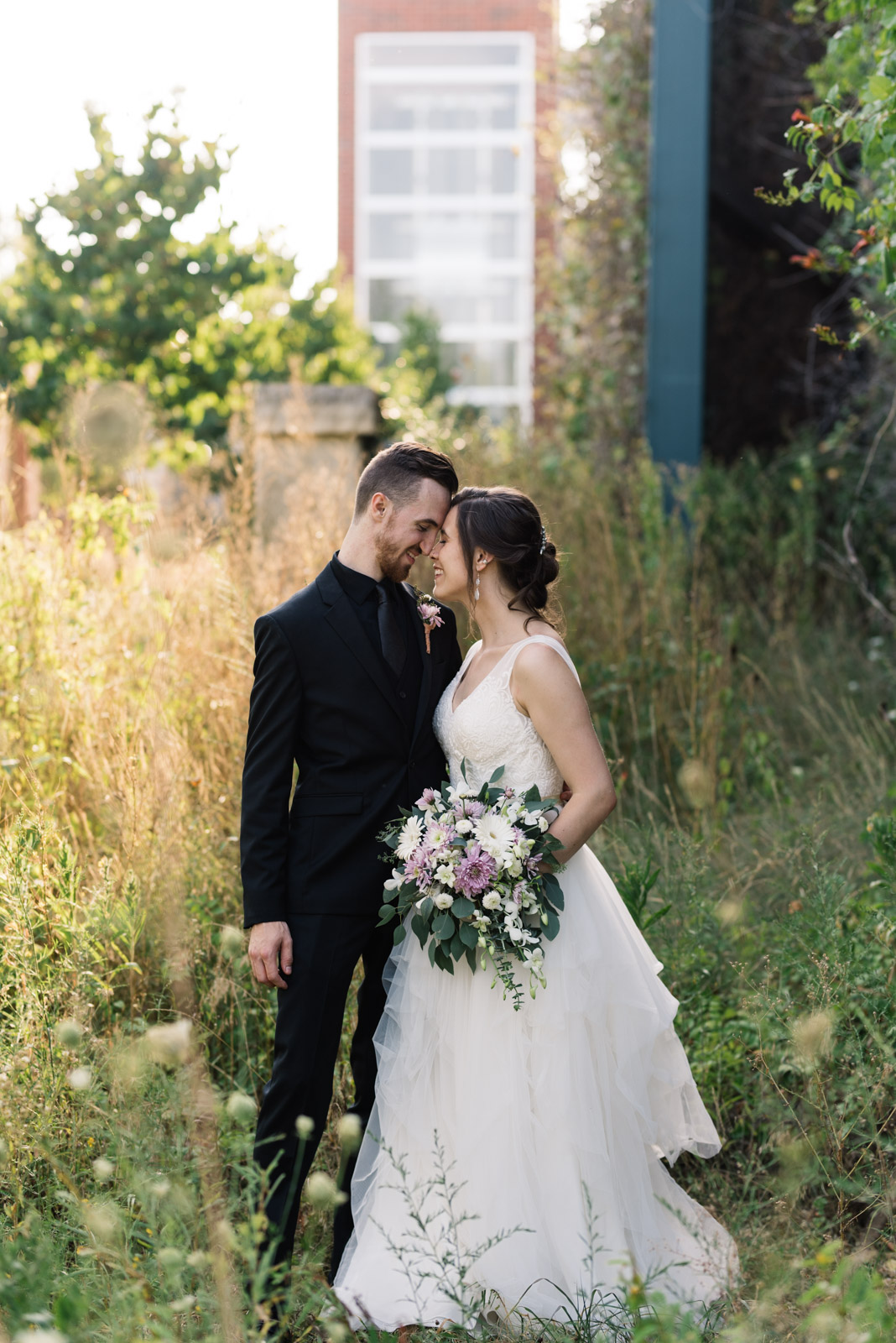 bride and groom cuddling Coralville Marriott Hotel wedding venue