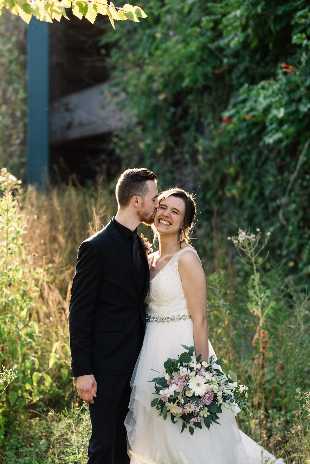 groom kissing brides cheek Coralville Marriott Hotel wedding venue