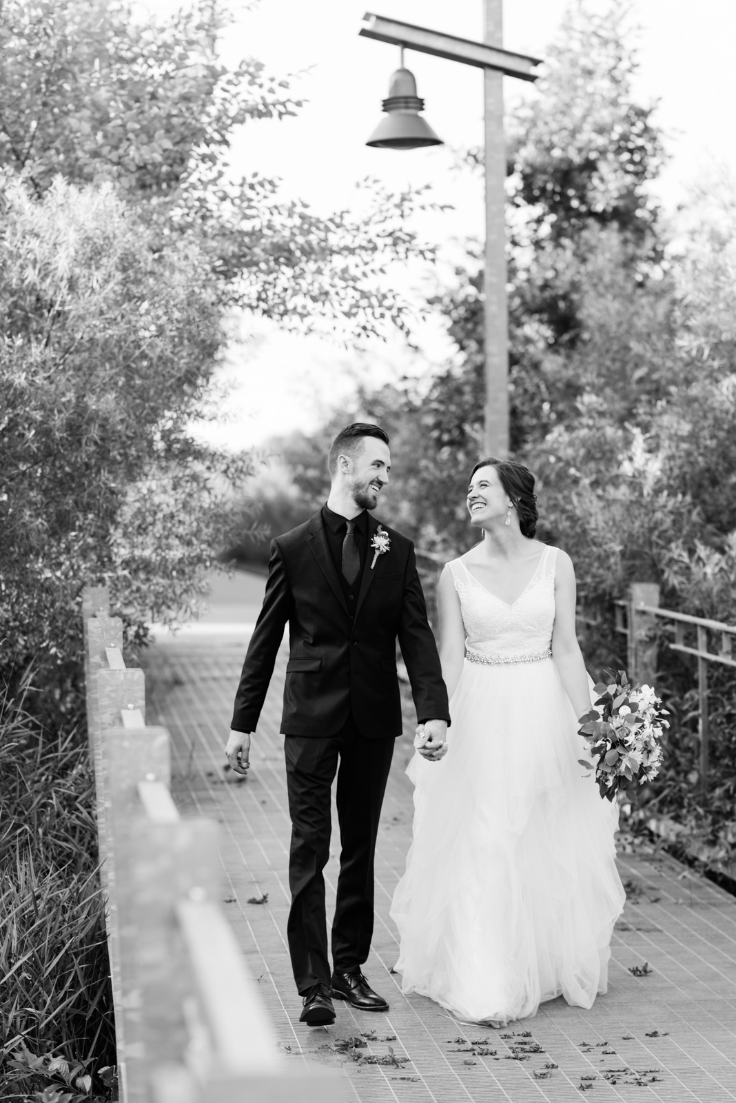 bride and groom walking outside Coralville Marriott Hotel wedding