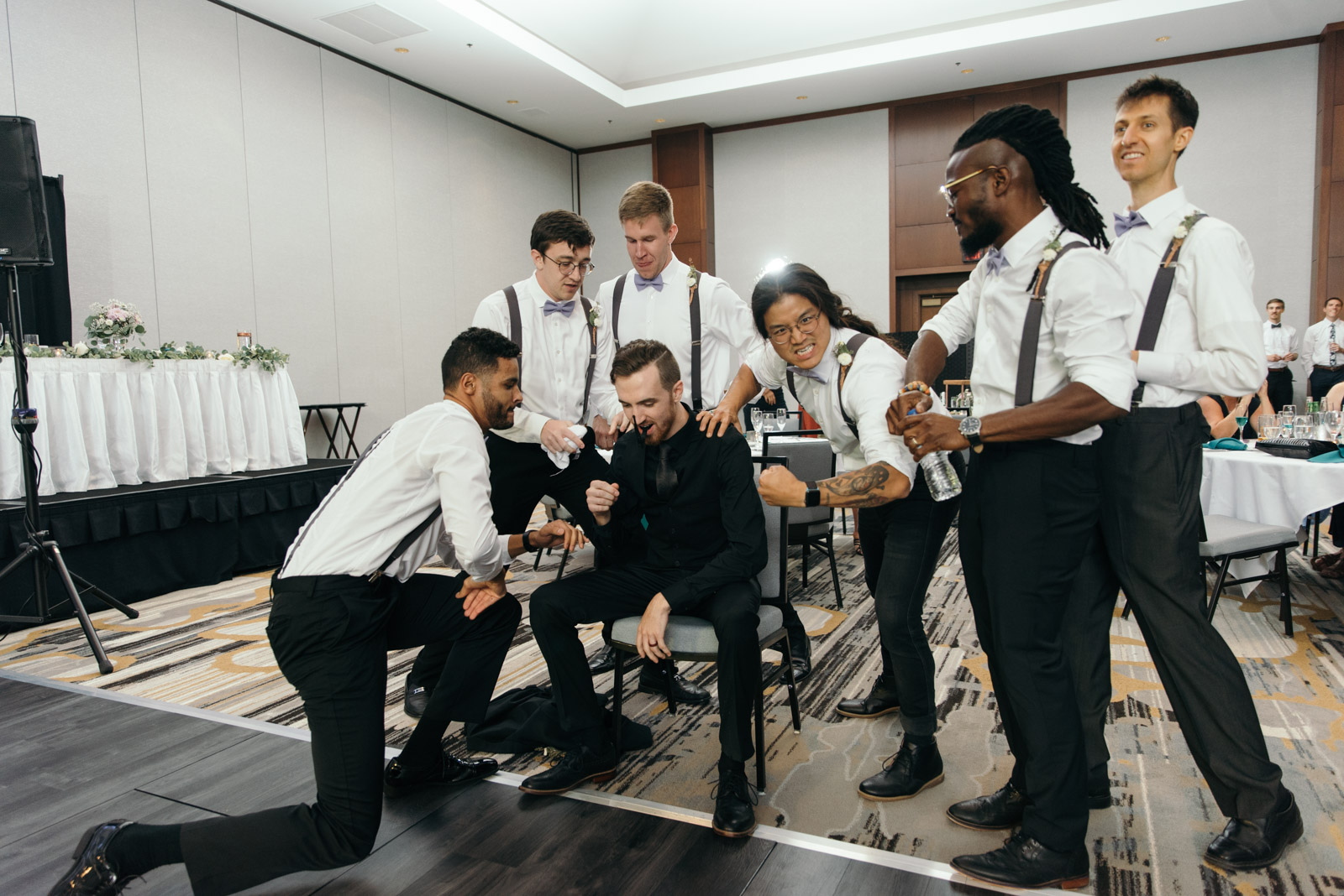 groom getting ready for dance battle Coralville Marriott Hotel wedding venue