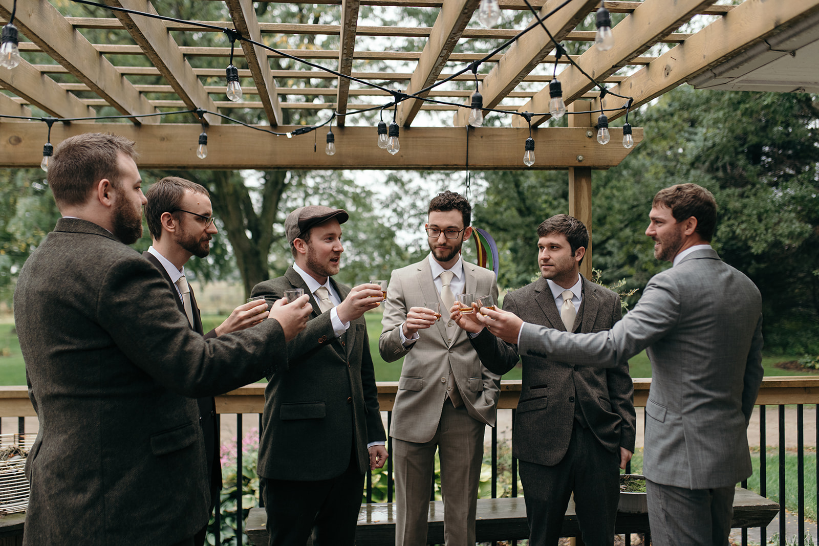 groom and groomsmen cheering glasses wellman iowa wedding