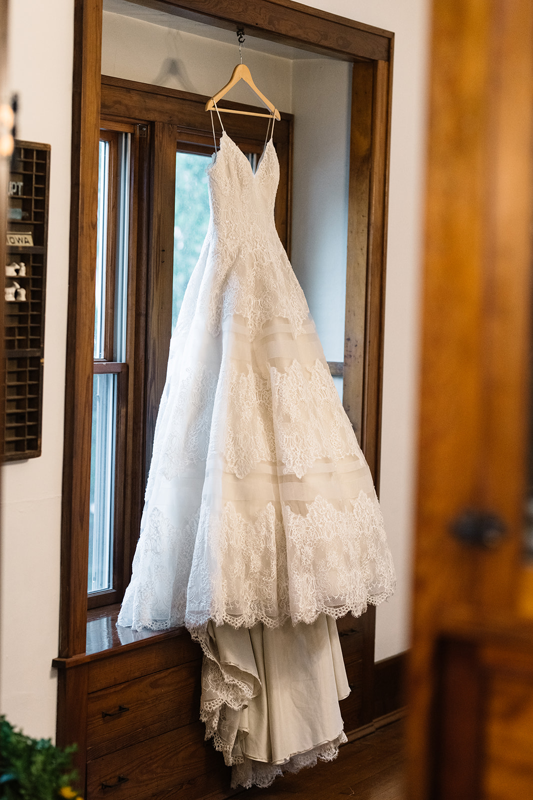 wedding dress hanging in window october iowa wedding