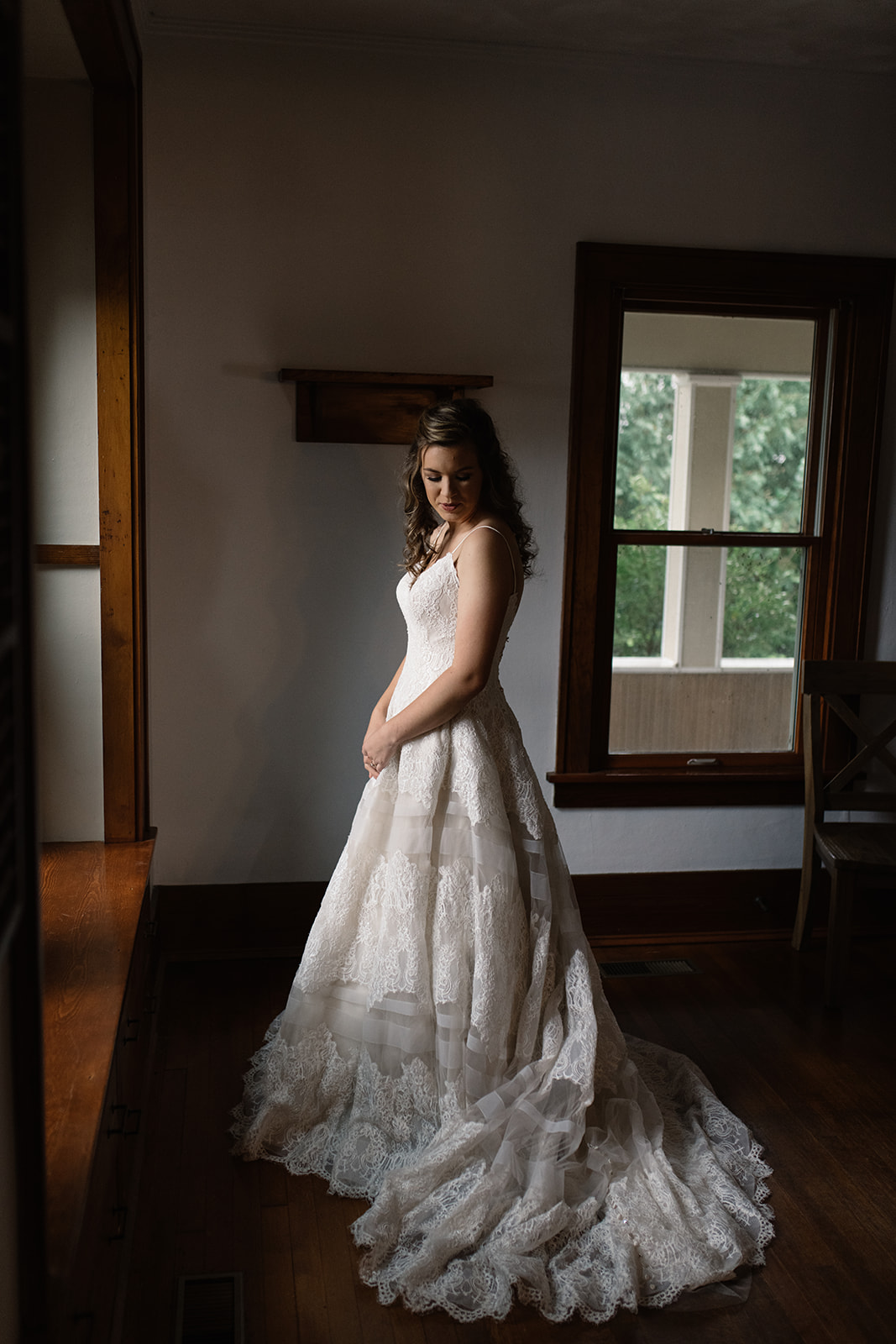 bride looking at wedding dress wellman iowa wedding