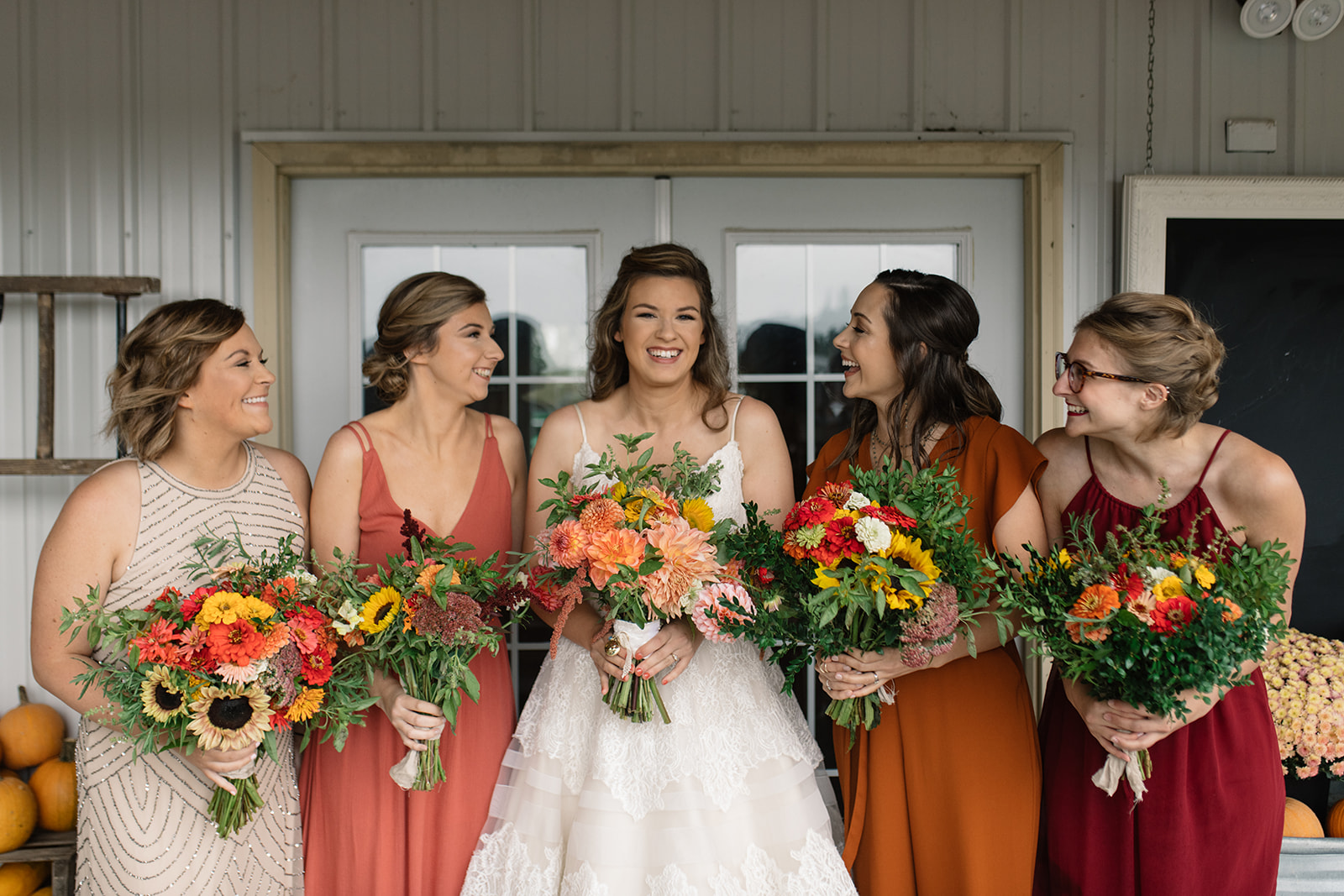 bride and bridesmaids with under a tin roof flower bouquets