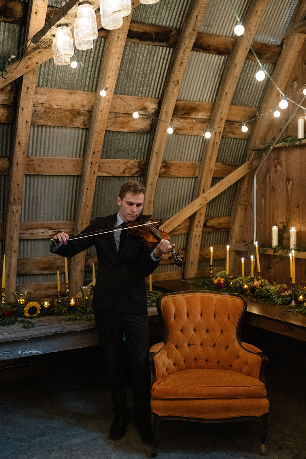violinist playing at wedding ceremony under twinkly lights iowa city wedding