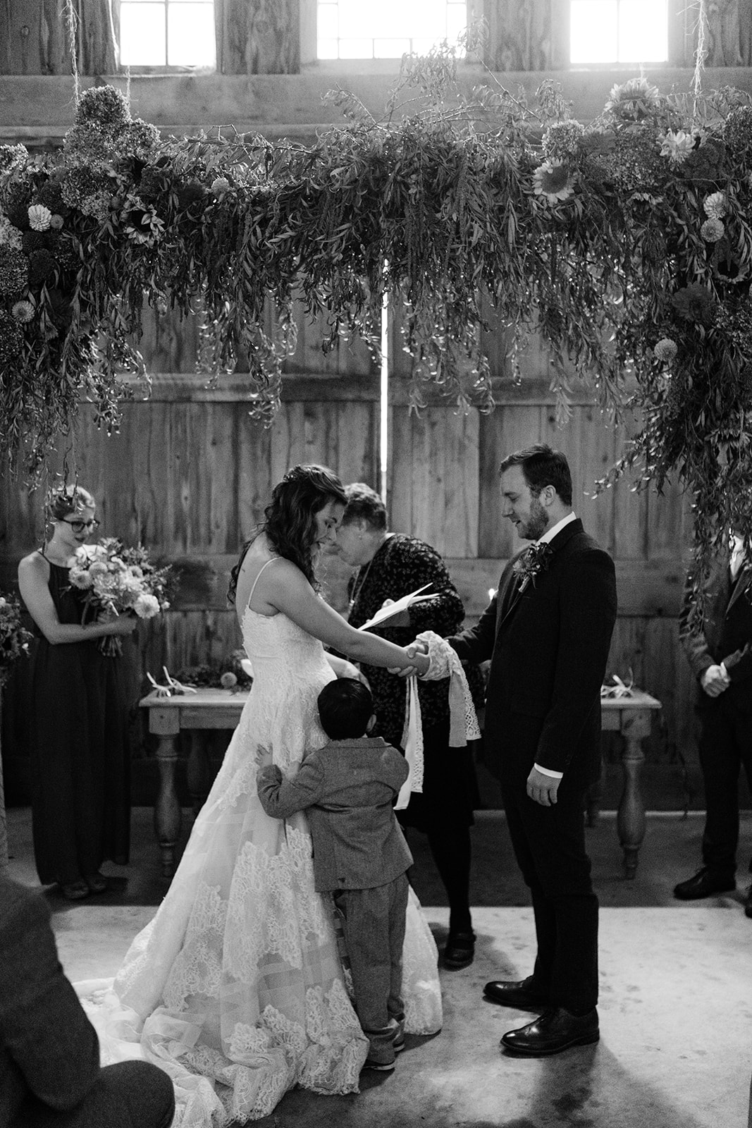 bride hugging son during wedding ceremony iowa october wedding