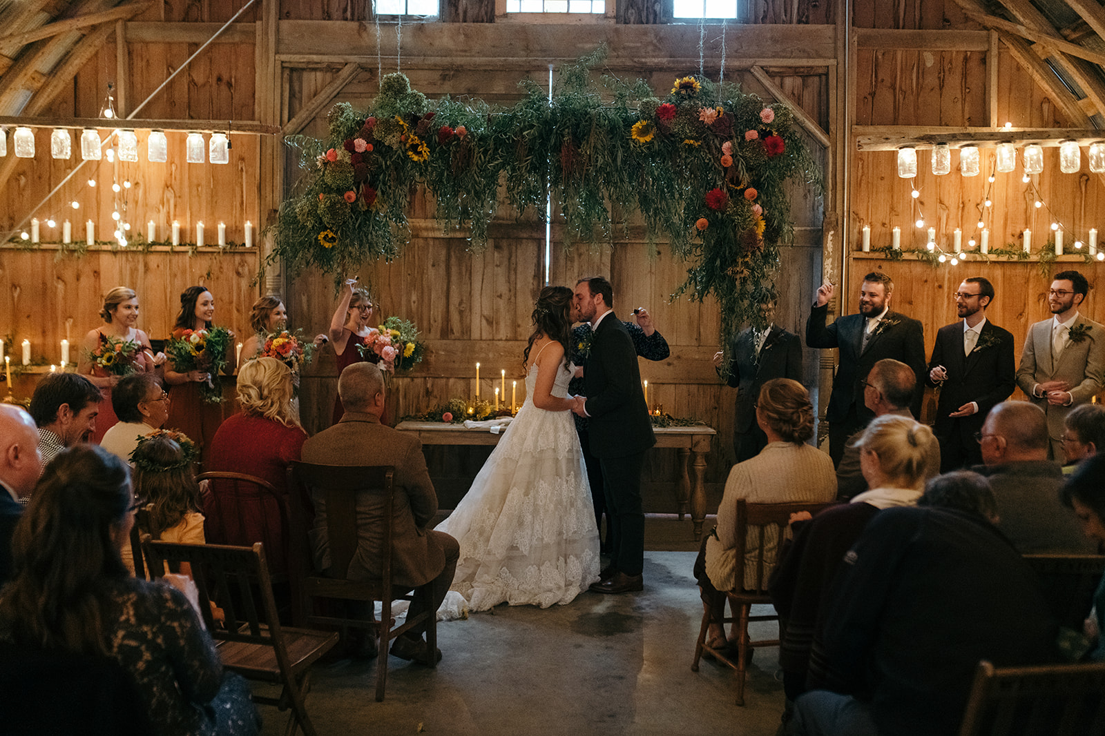 bride and groom first kiss the barn wellman iowa wedding venue