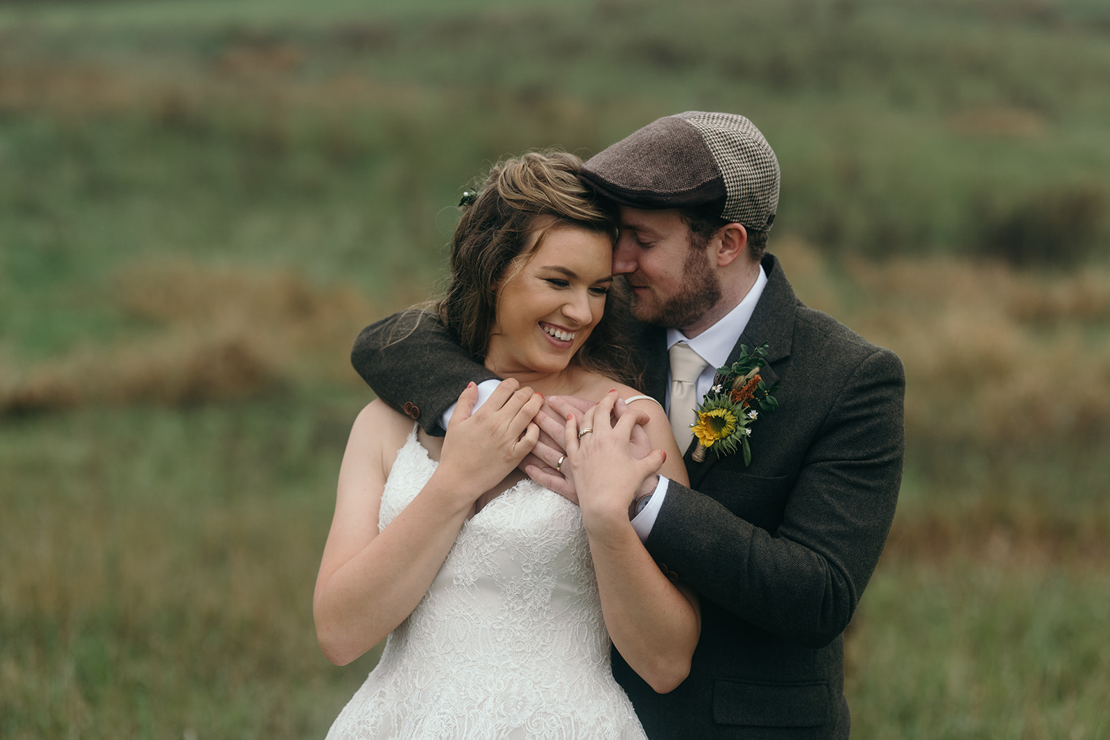 bride and groom cuddling in field iowa october wedding