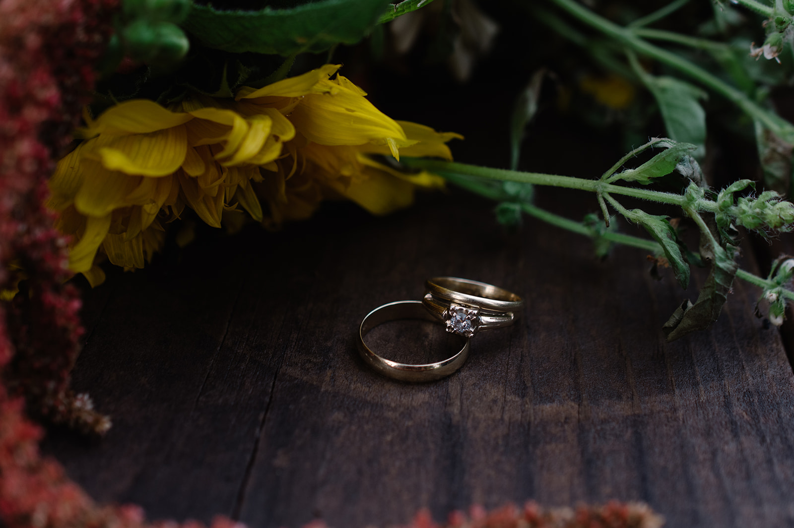 wedding rings with wild flowers under a tin roof wedding