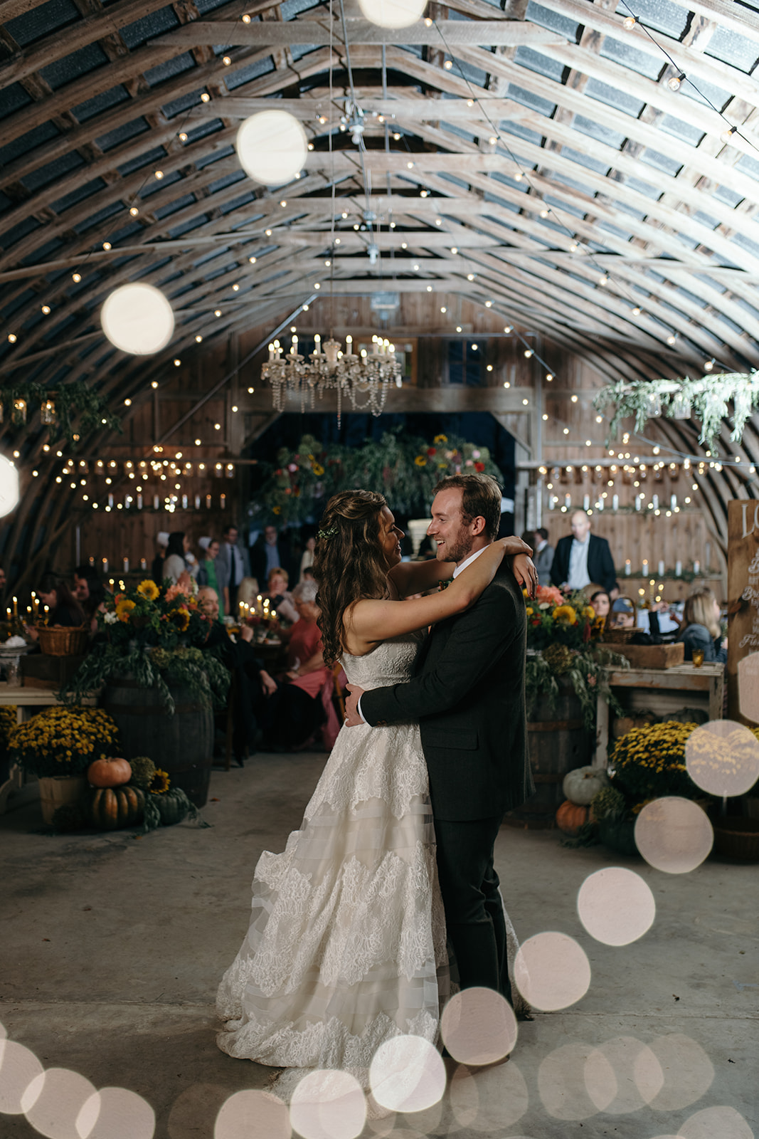 bride and groom first dance under twinkly lights the barn wedding venue