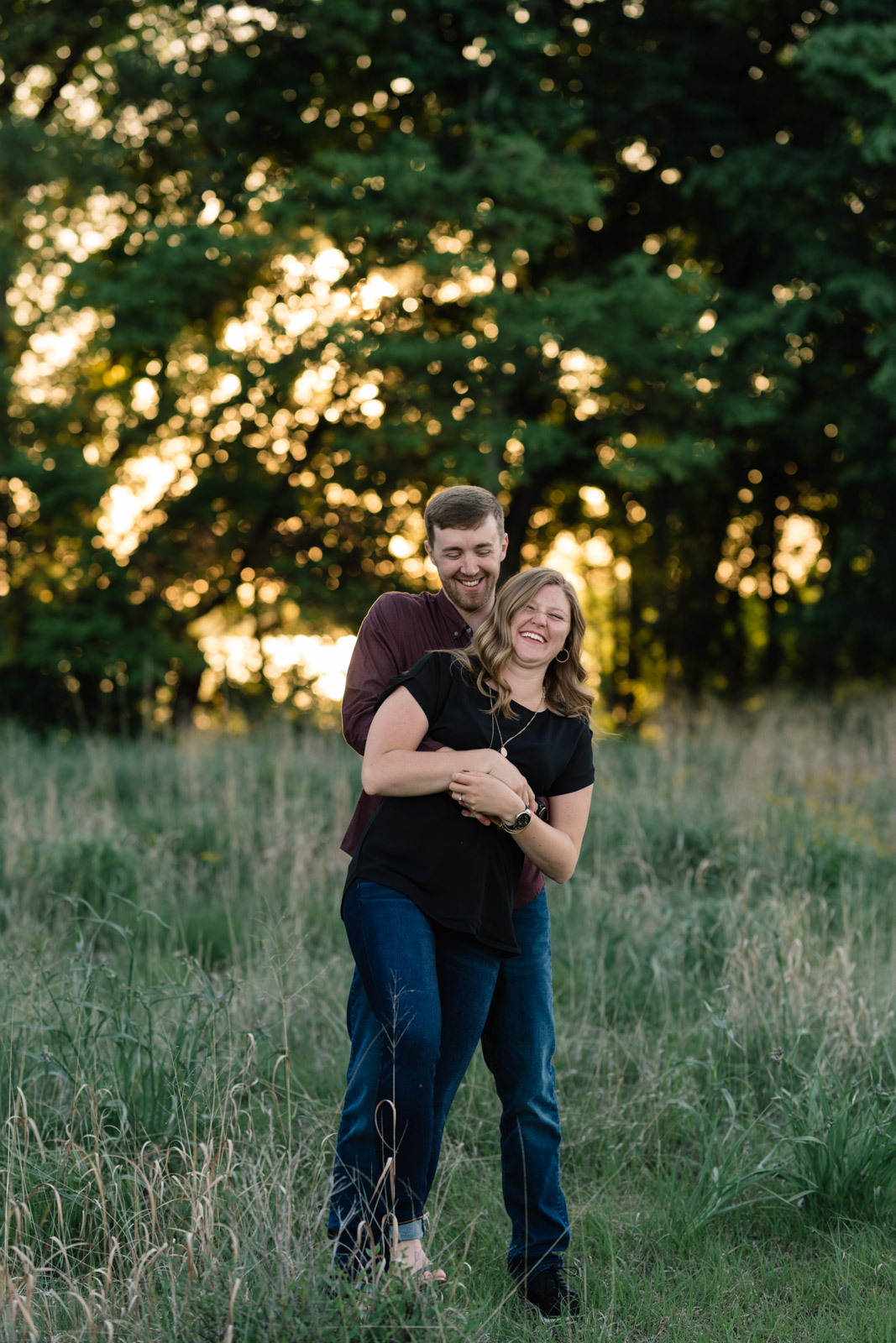 couple in field cedar falls June engagement session