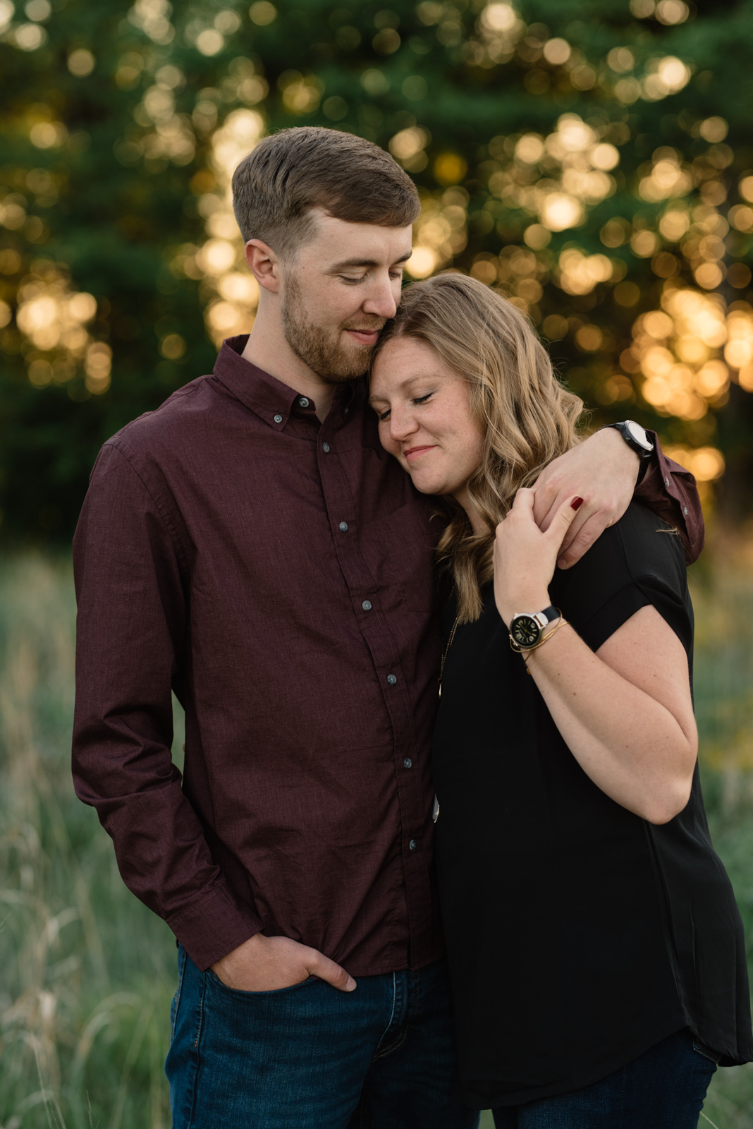 couple cuddling cedar falls June sunset engagement session