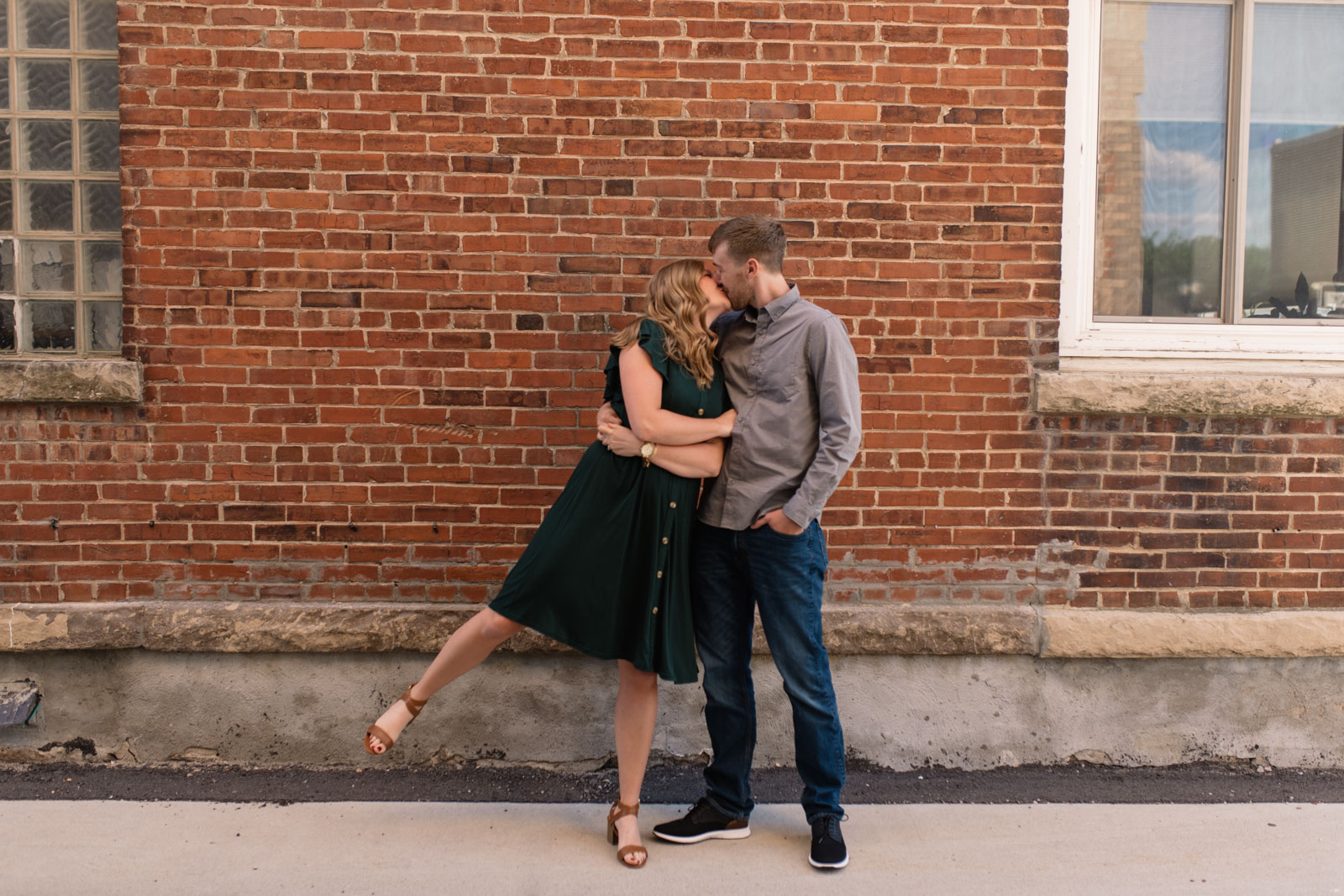 couple by brick wall cedar falls engagement