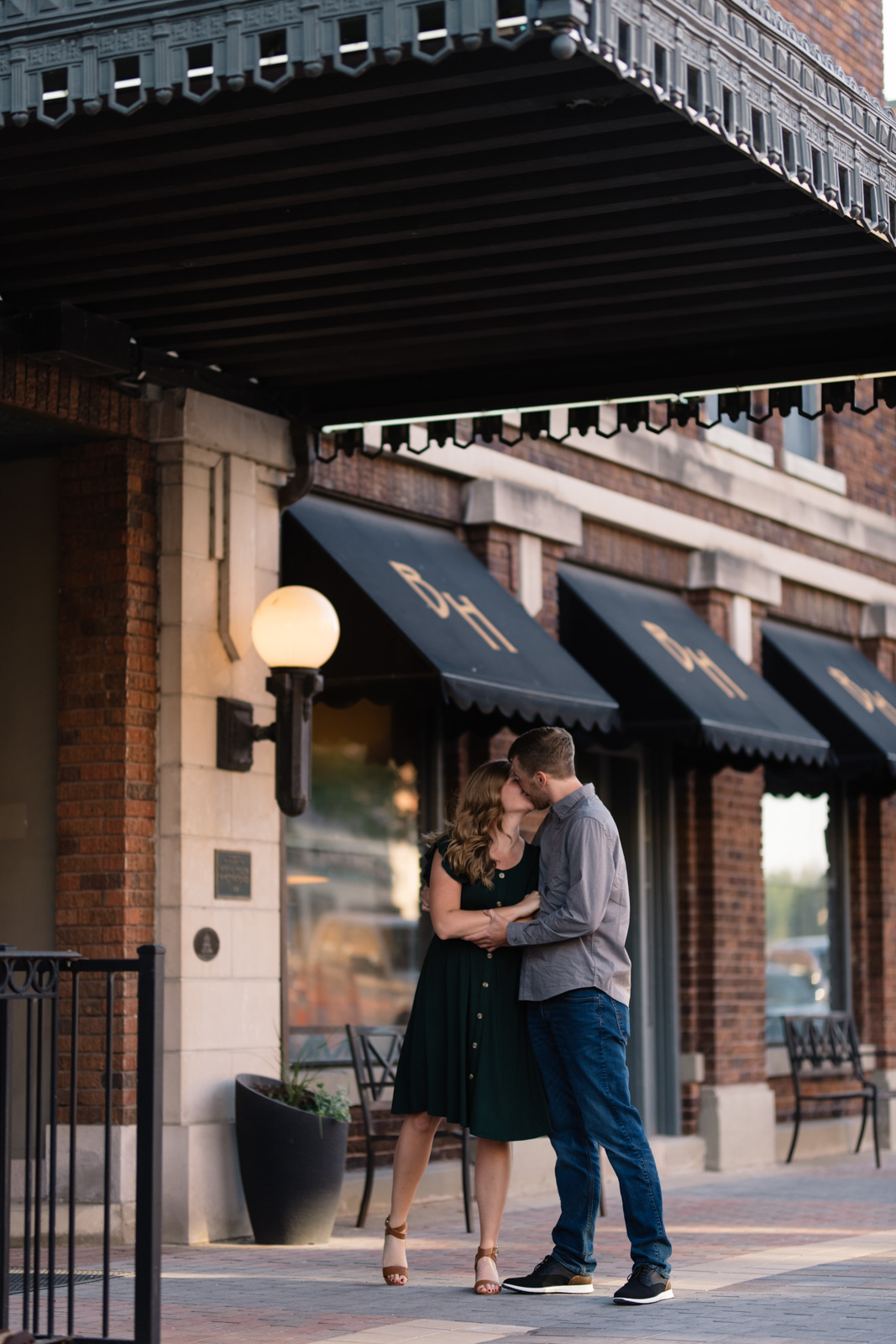 couple kissing engagement session main street cedar falls