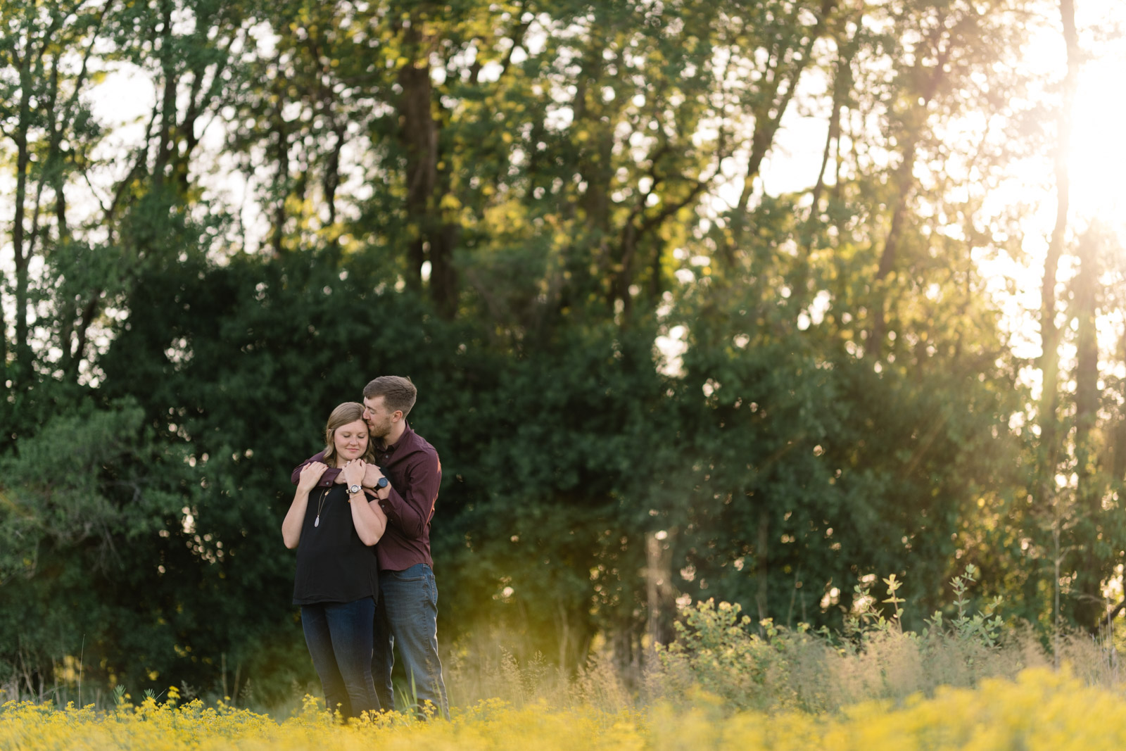 couple in field george wyth state park engagement