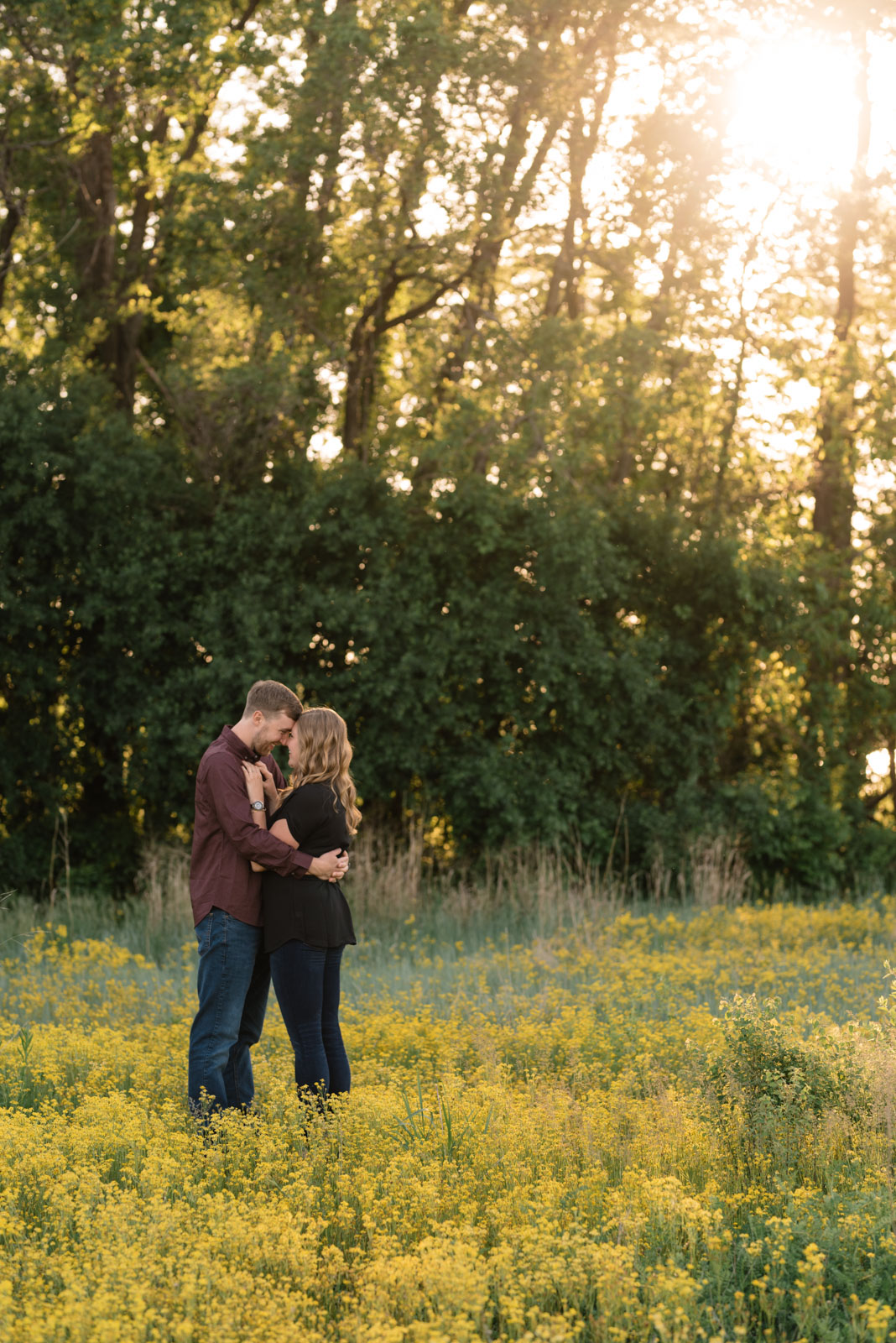 couple in field sunset george wyth state park engagement