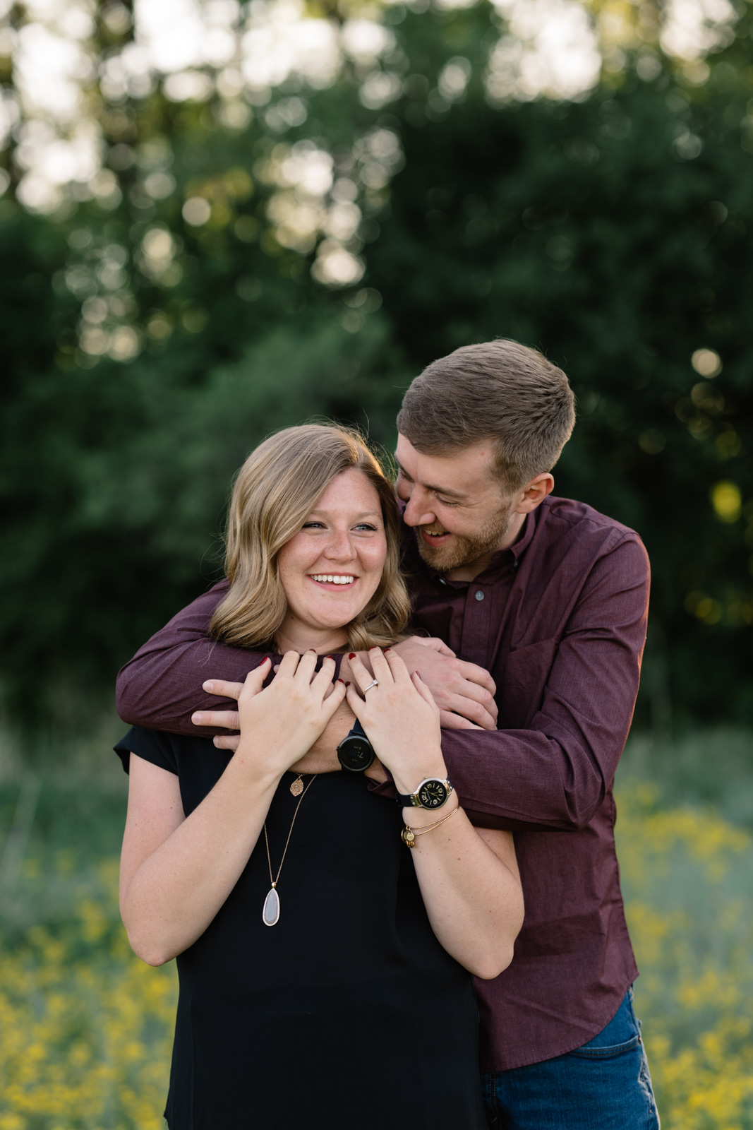 couple laughing in field sunset george wyth state park engagement