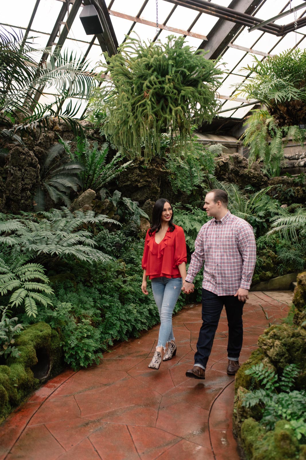 couple walking through lincoln park conservatory engagement session