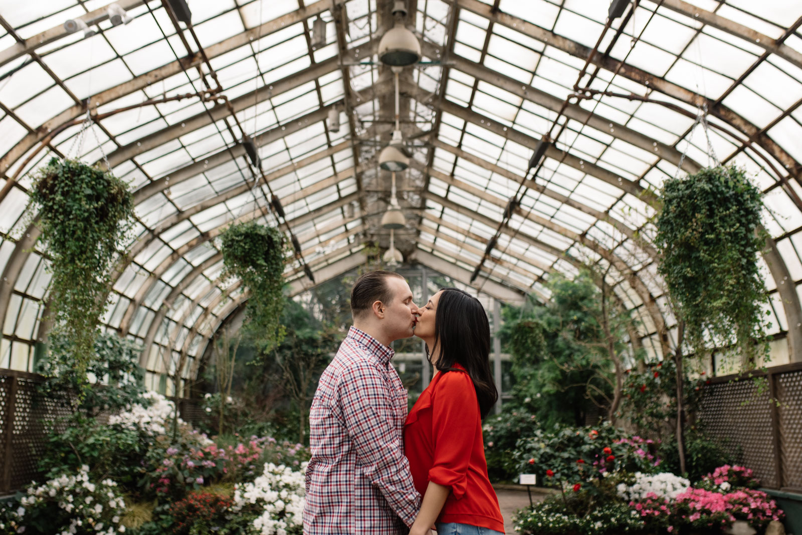 couple kissing in greenhouse lincoln park conservatory engagement session