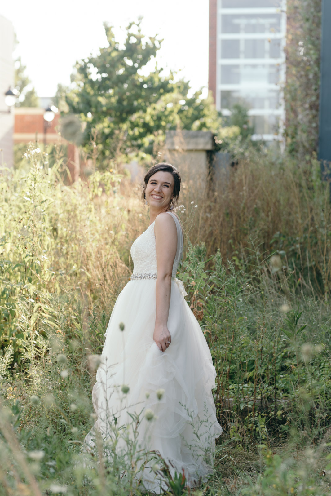 bride playing with wedding dress outside iowa city wedding