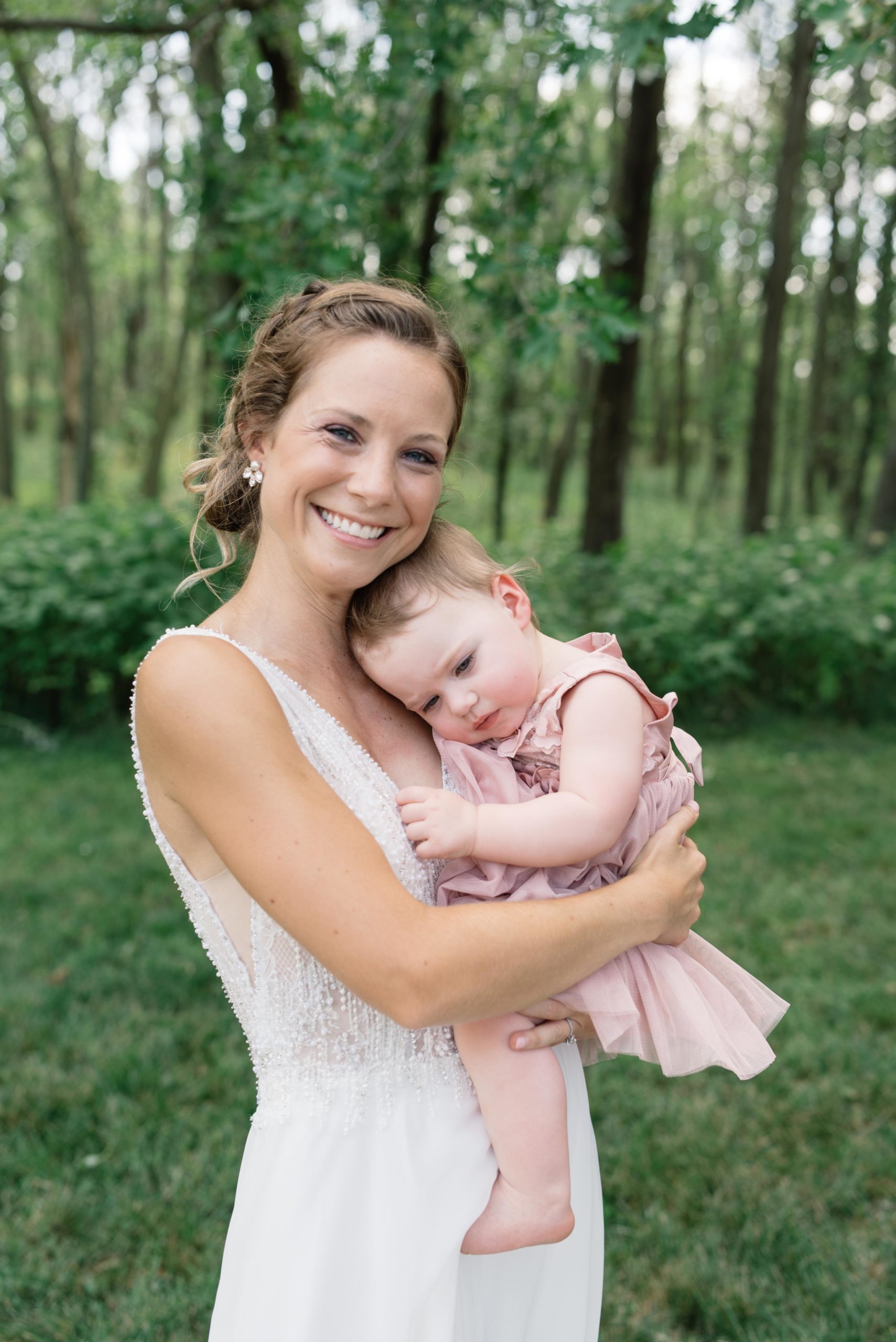 flower girl snuggling with bride schafer century barn wedding venue