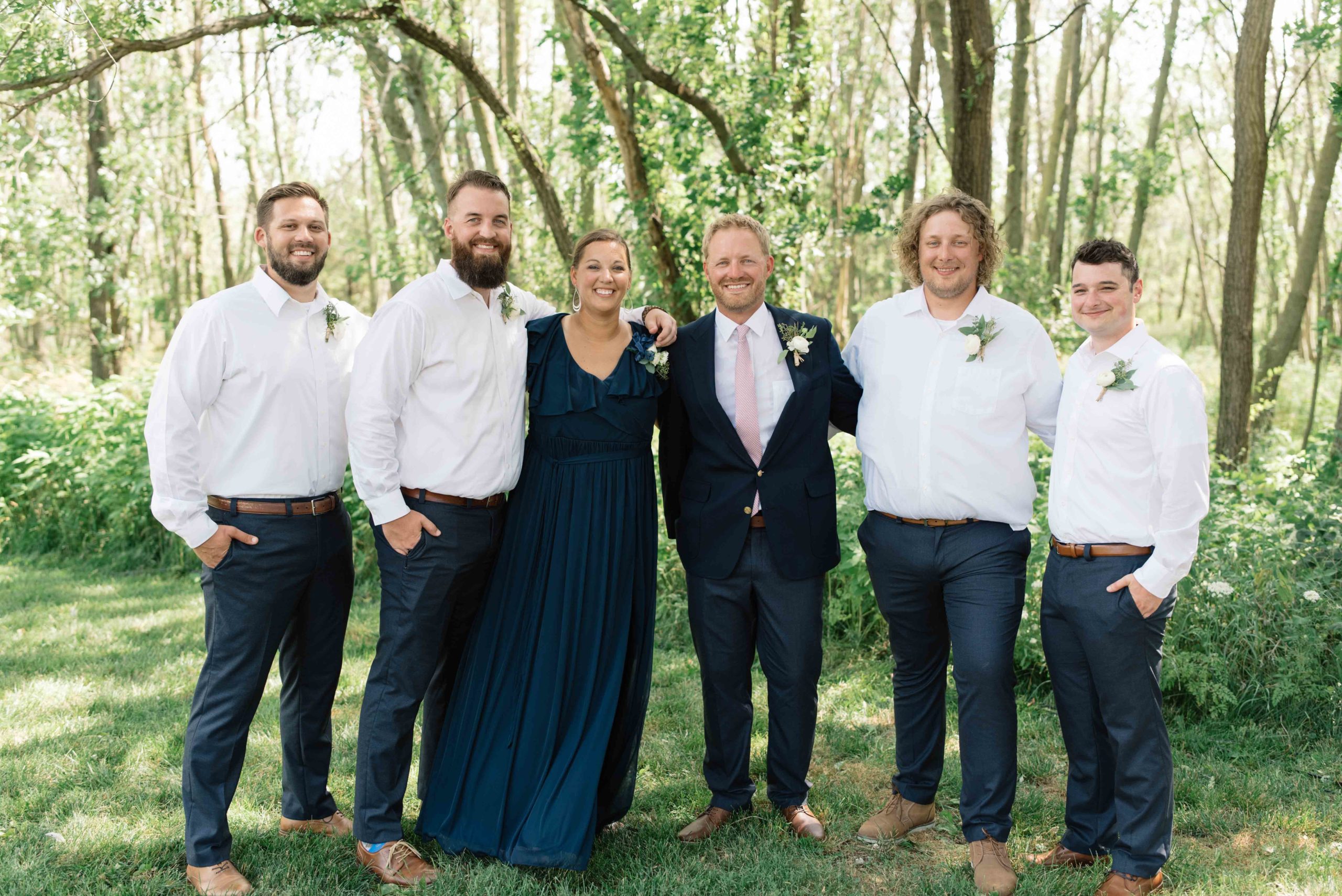 groomsmen laughing with groom schafer century barn Iowa wedding venue